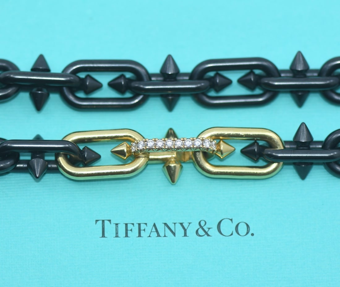 Tiffany & Co Pharrell Williams 18K Gold Titanium Diamond Necklace: Tiffany & Co Pharrell Williams 18K Gold Titanium Diamond Necklace This stunning necklace from Tiffany & Co., designed in collaboration with Pharrell Williams, features an exquisite combination of 18K 