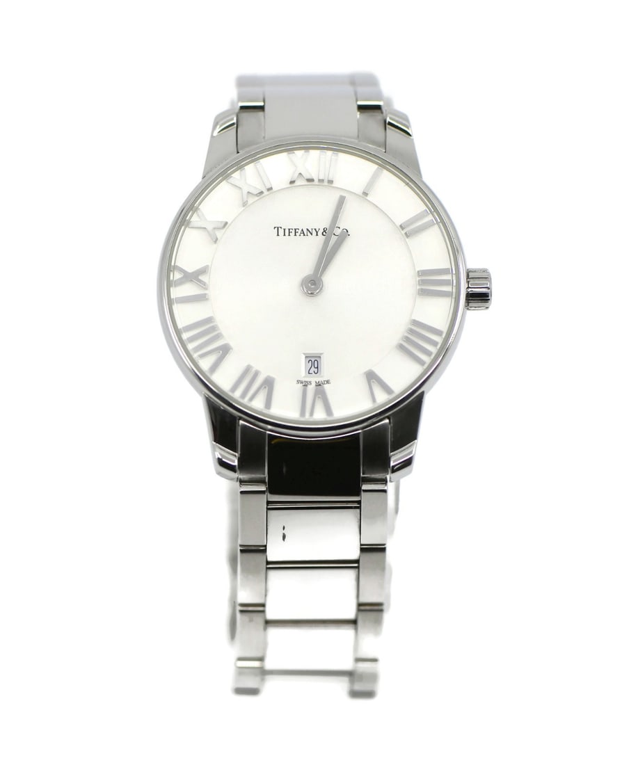 Atlas Quartz Wristwatch by Tiffany & Co Stainless Steel Silver Dial: Atlas Quartz Wristwatch by Tiffany & Co Stainless Steel Silver Dial This Tiffany & Co. Atlas wristwatch features a stainless steel case and band, paired with a silver dial and an analog display. The w