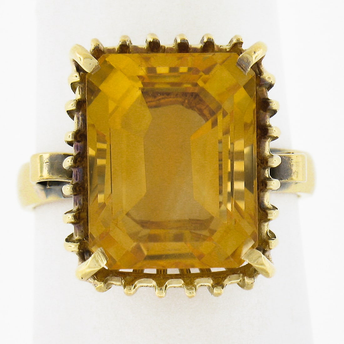 Vintage Unbranded Citrine Cocktail Ring in 18k Yellow Gold: Vintage Unbranded Citrine Cocktail Ring in 18k Yellow Gold Vintage cocktail ring featuring a natural emerald-cut citrine in a prong setting with an openwork basket design. Crafted in solid 17-18k yell