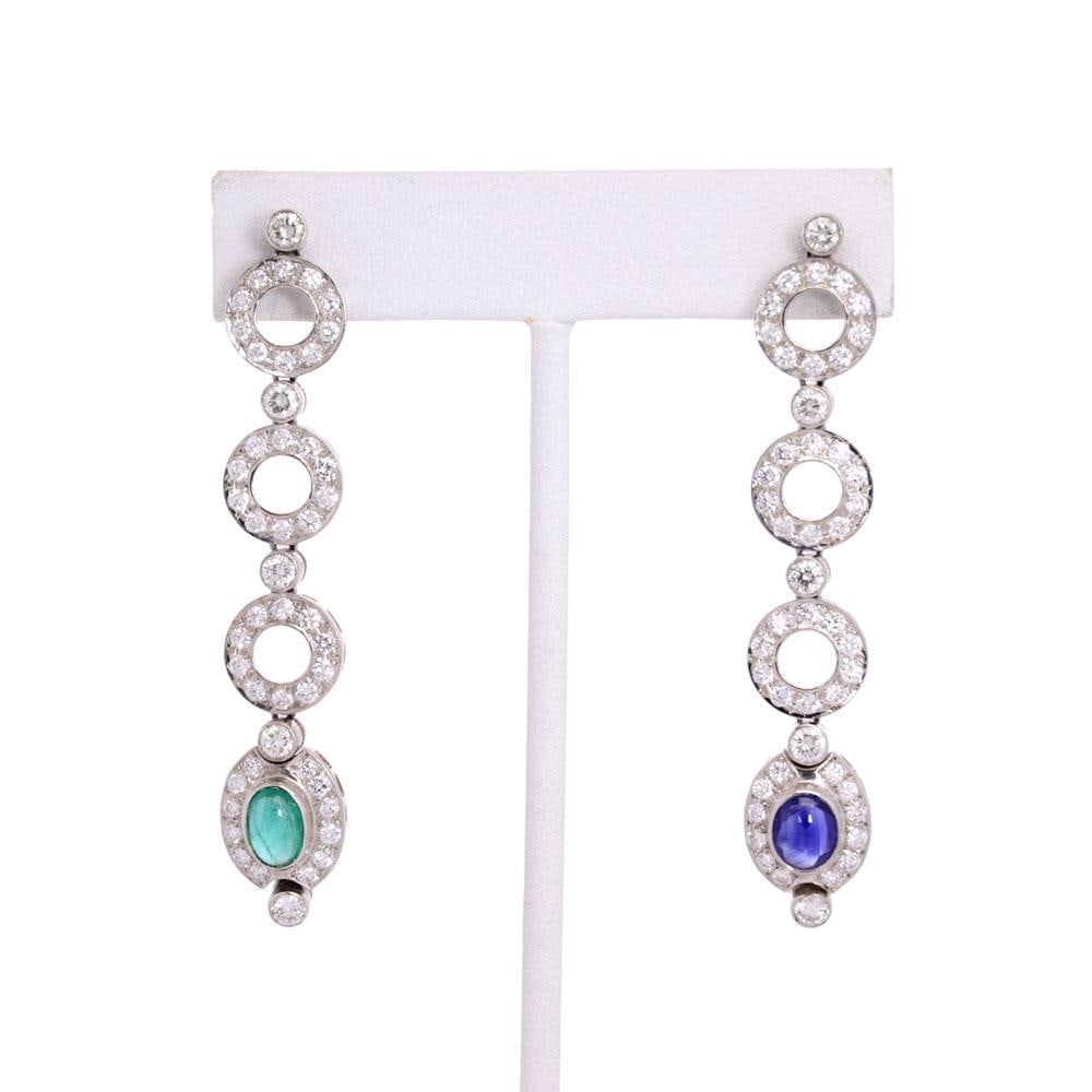 18k White Gold Diamond Emerald Sapphire Long Drop Earrings: 18k White Gold Diamond Emerald Sapphire Long Drop Earrings Elevate your elegance with these stunning long drop dangle earrings, expertly crafted from luxurious 18k white gold featuring a polished fini