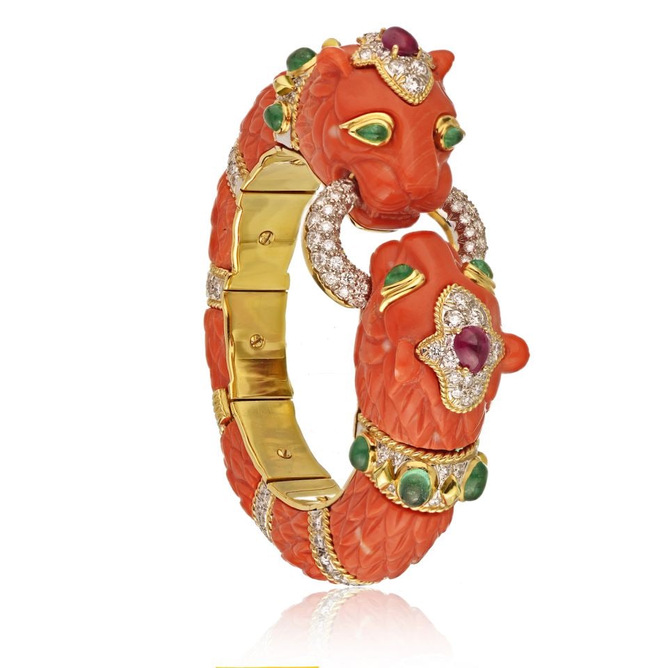 David Webb Platinum 18K Gold Coral Lion Head Bangle Bracelet: David Webb Platinum 18K Gold Coral Lion Head Bangle Bracelet This exquisite bangle bracelet showcases the artistry of David Webb, featuring a striking design that embodies his signature animal motif. 
