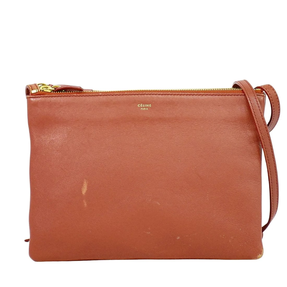 Celine Trio red leather crossbody bag: Celine Trio red leather crossbody bag This Celine Trio Crossbody Bag is crafted from red leather and designed for women. It features a compact silhouette and is made in Italy. The bag shows signs of u