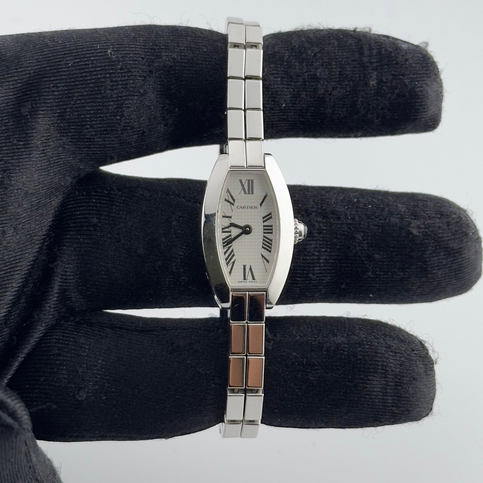Ladies Cartier Tonneau Lanieres Watch Ref 2545 Silver Roman Dial White Gold Bracelet: Ladies Cartier Tonneau Lanieres Watch Ref 2545 Silver Roman Dial White Gold Bracelet This Cartier Tonneau Lanieres wristwatch features a silver Roman numeral dial and a two-row white gold bracelet. De
