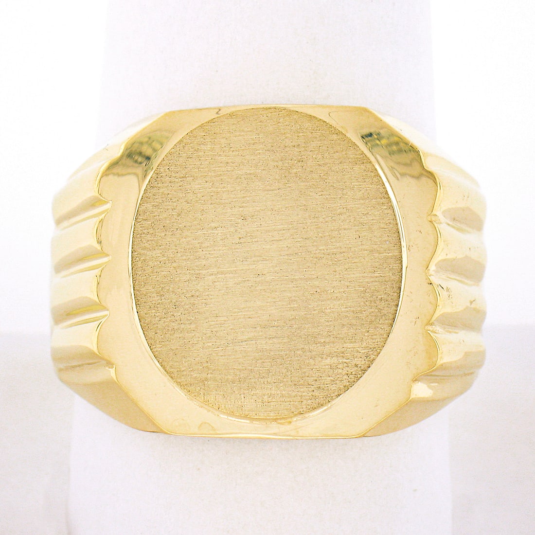Mens 14K Yellow Gold Engravable Oval Brushed Signet Ring: Mens 14K Yellow Gold Engravable Oval Brushed Signet Ring This exquisite men's signet ring is crafted from solid 14K yellow gold, featuring a brushed oval top with elegantly grooved polished sides. The