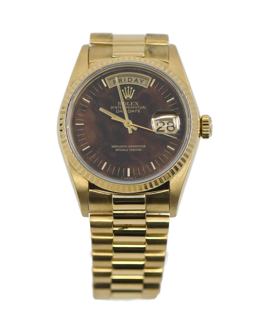 36mm Yellow Gold Rolex Day-Date 18038 Brown Wood Dial Automatic Watch: 36mm Yellow Gold Rolex Day-Date 18038 Brown Wood Dial Automatic Watch This Rolex Day-Date wristwatch features a distinctive wood dial set within an 18K yellow gold case and is paired with the signatur