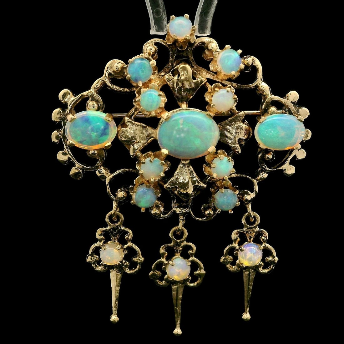 Vintage Victorian Revival Yellow Gold Opal Dangle Brooch Pendant: Vintage Victorian Revival Yellow Gold Opal Dangle Brooch Pendant This exquisite Vintage Victorian Revival pendant features a stunning array of natural opals. The design showcases three oval cabochon c