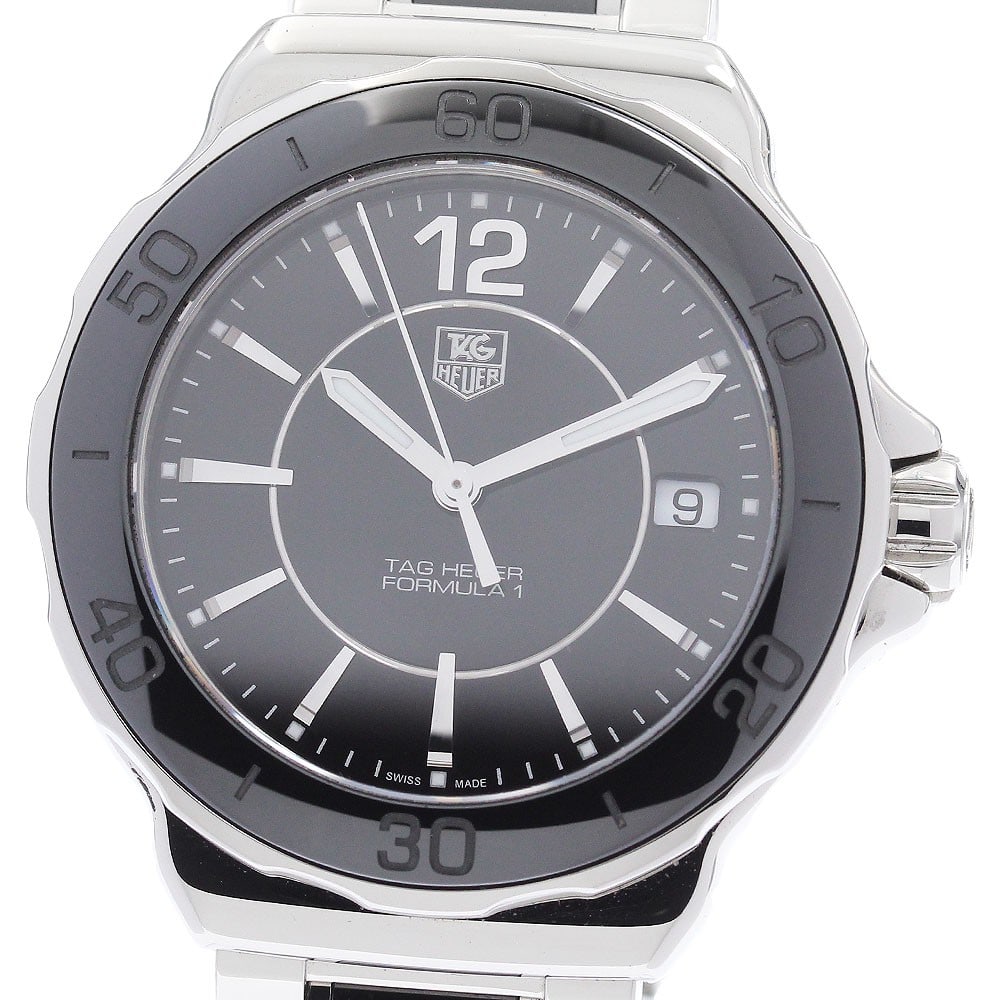 TAG Heuer Formula 1 Quartz Date Women's Watch WAH1210: TAG Heuer Formula 1 Quartz Date Women's Watch WAH1210 This pre-owned TAG Heuer Formula 1 Date Quartz women's wristwatch features a stainless steel and ceramic case and bracelet, complemented by a blac