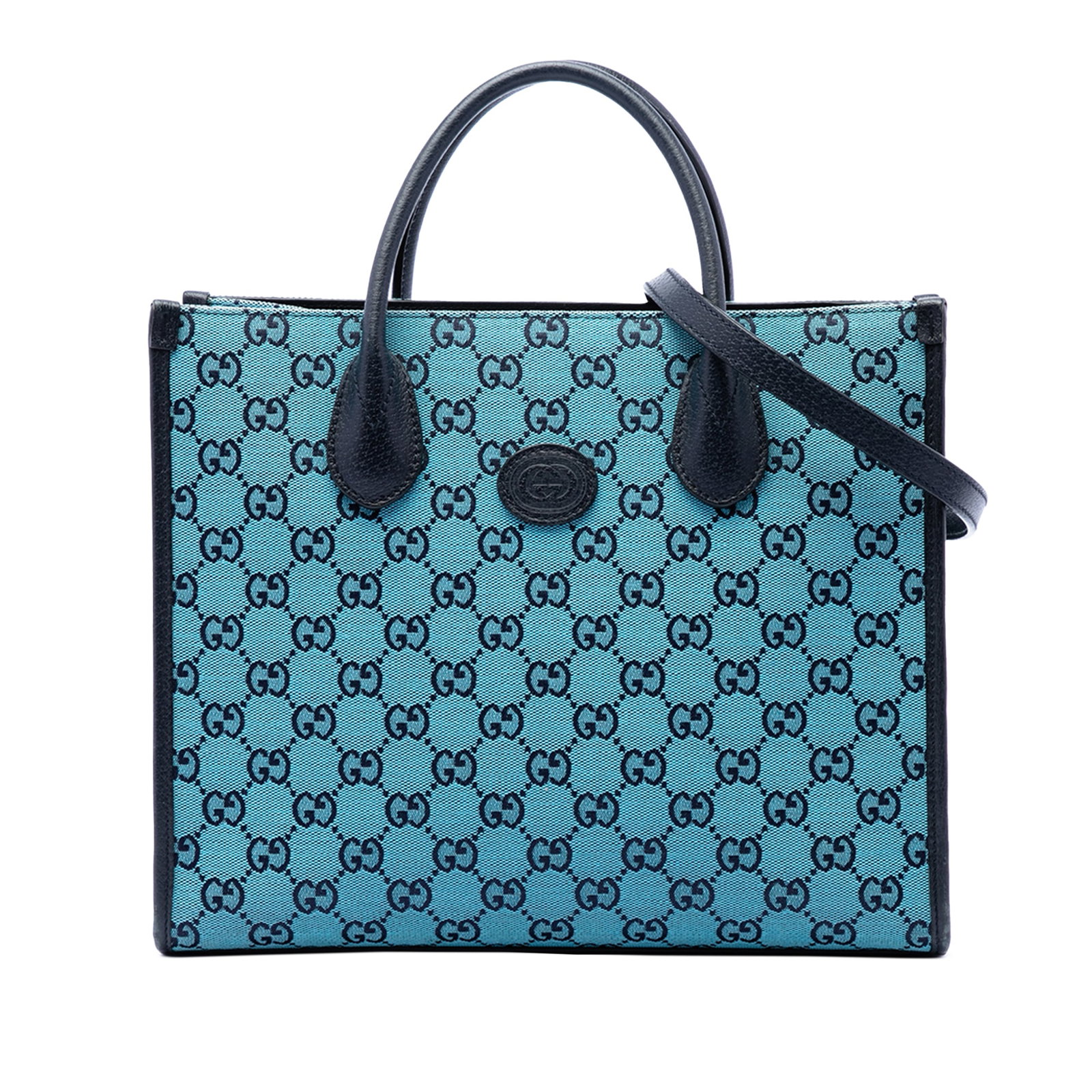 Gucci blue canvas tote with leather trim and strap: Gucci blue canvas tote with leather trim and strap This Gucci Small GG Canvas Interlocking G Tote features a canvas body with leather trim, rolled leather handles, and a detachable flat leather strap.