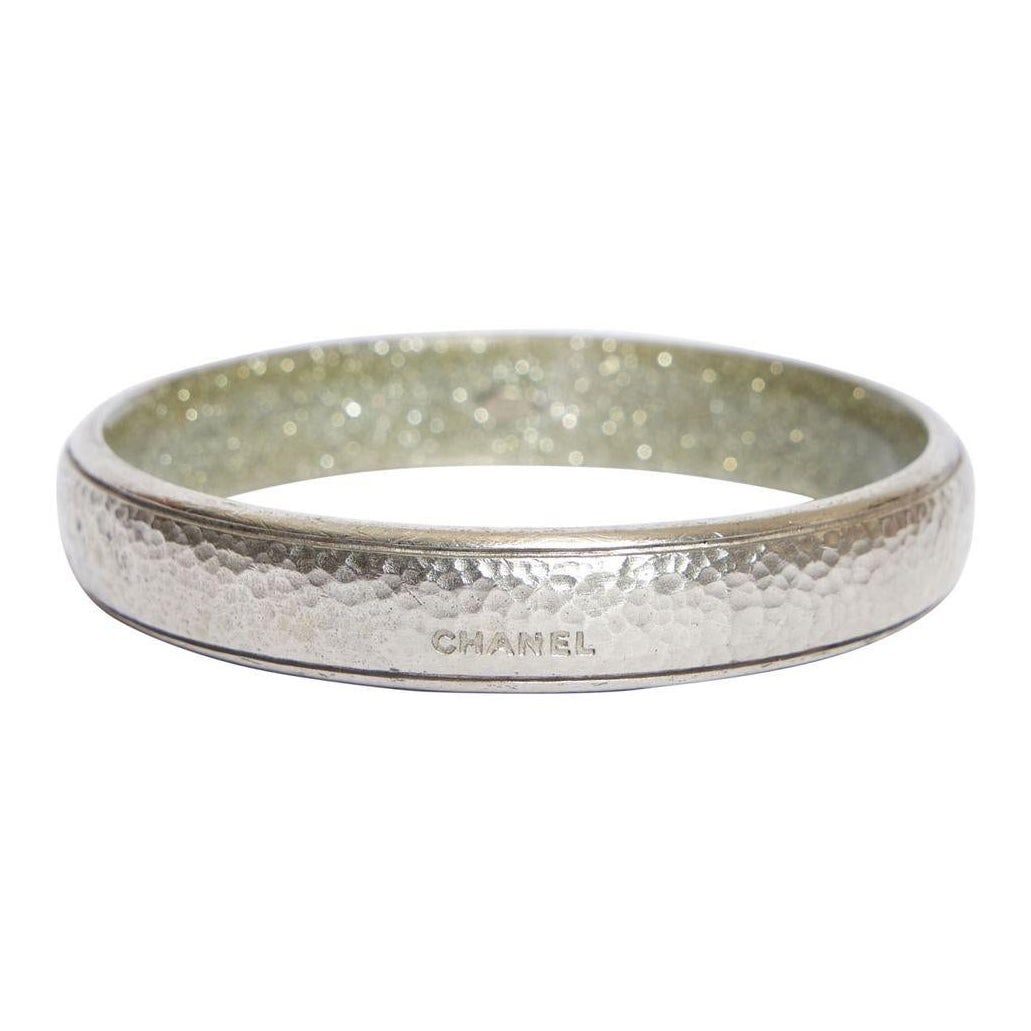 Chanel Silver Tone Hammered Bangle Bracelet Spring 2007 Collection: Chanel Silver Tone Hammered Bangle Bracelet Spring 2007 Collection This exquisite Chanel silver tone hammered metal bangle bracelet is a stunning accessory from the Spring 2007 collection. Crafted fro