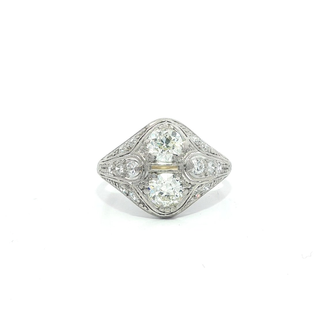 Antique Edwardian Platinum 1.25ctw Dual Diamond Ring: Antique Edwardian Platinum 1.25ctw Dual Diamond Ring This exquisite Antique Edwardian ring features a captivating design adorned with two natural old European cut diamonds, showcasing a total carat we