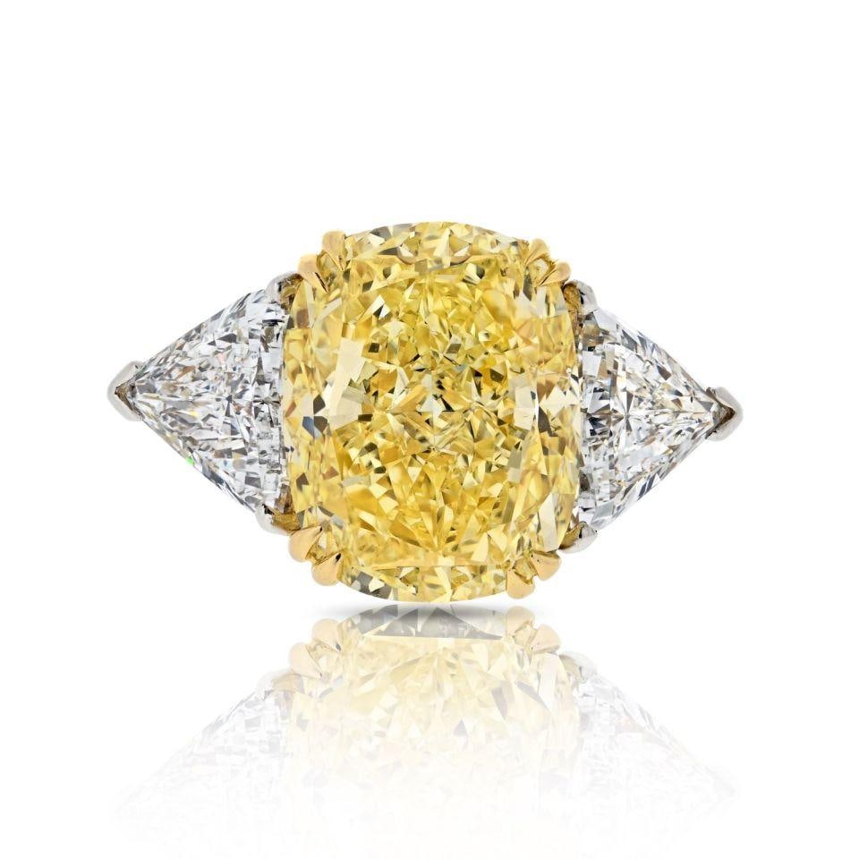 GIA Certified Three Stone Diamond Ring Platinum 18K Yellow Gold Size 6.5: GIA Certified Three Stone Diamond Ring Platinum 18K Yellow Gold Size 6.5 This stunning three-stone engagement ring features an impressive 8.70ct VVS2 cushion-cut center diamond with a Fancy Intense Ye