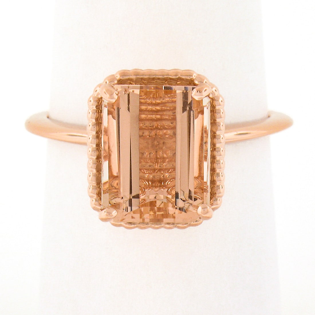14k Rose Gold 3.13ct Emerald Cut Morganite Solitaire Twisted Wire Ring: 14k Rose Gold 3.13ct Emerald Cut Morganite Solitaire Twisted Wire Ring Introducing a stunning 14k rose gold ring featuring a 3.13 carat emerald cut morganite at its center, elegantly prong set within 