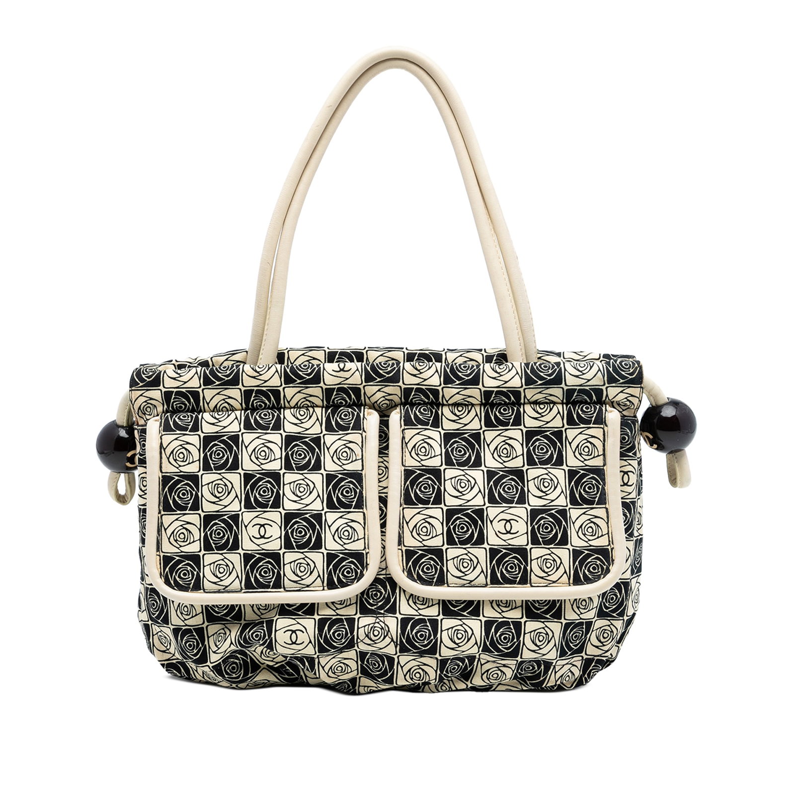 Chanel Camellia Canvas Tote with Coco Ball Detail: Chanel Camellia Canvas Tote with Coco Ball Detail This Chanel Camellia Canvas Coco Ball Tote features a canvas body with rolled leather straps, an open top with a magnetic snap closure, and an interio
