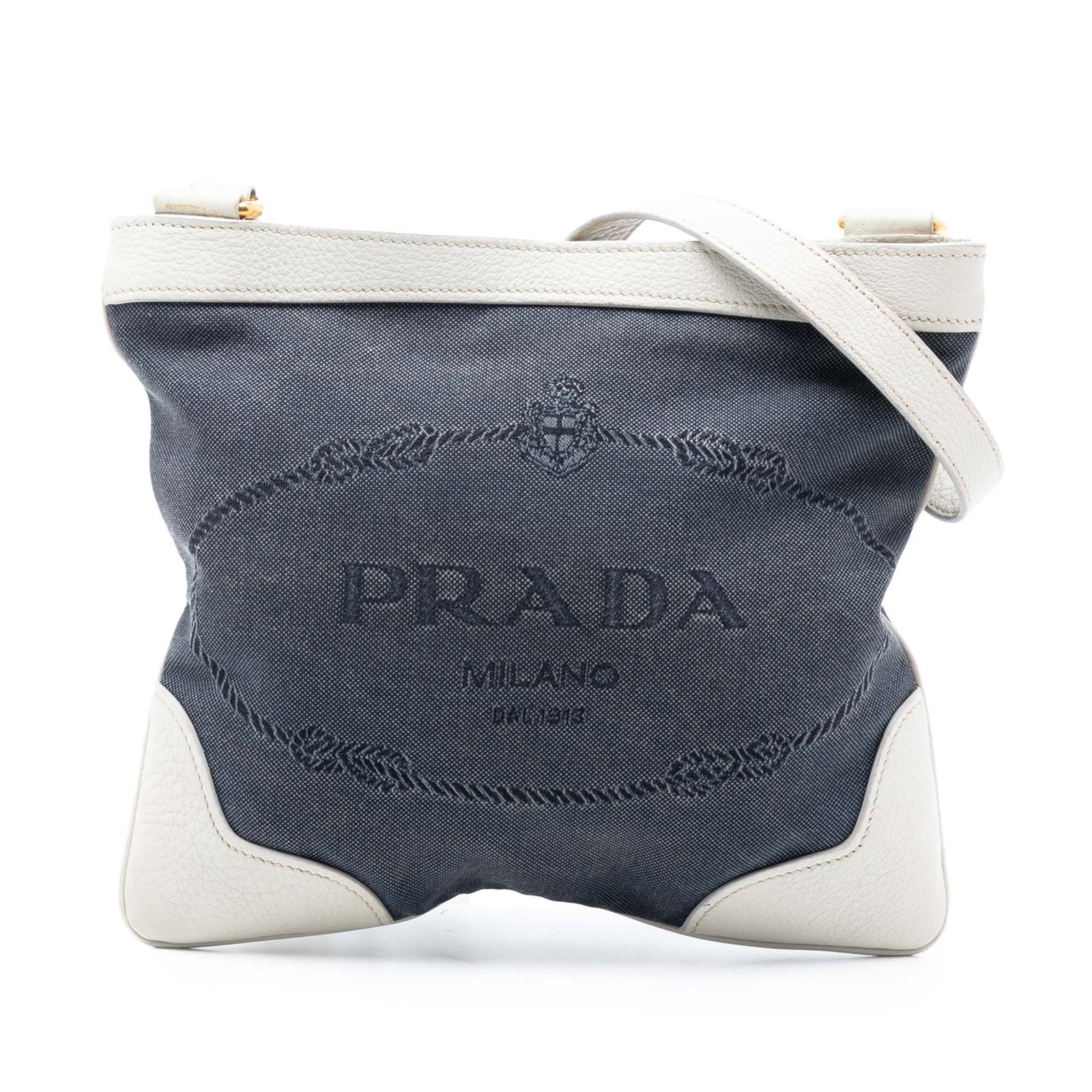 Blue Canvas Crossbody Bag with Logo by Prada Canapa: Blue Canvas Crossbody Bag with Logo by Prada Canapa This Prada Canvas Canapa Logo Crossbody bag features a blue canvas body accented with leather trim. It is designed with an adjustable flat strap, a 