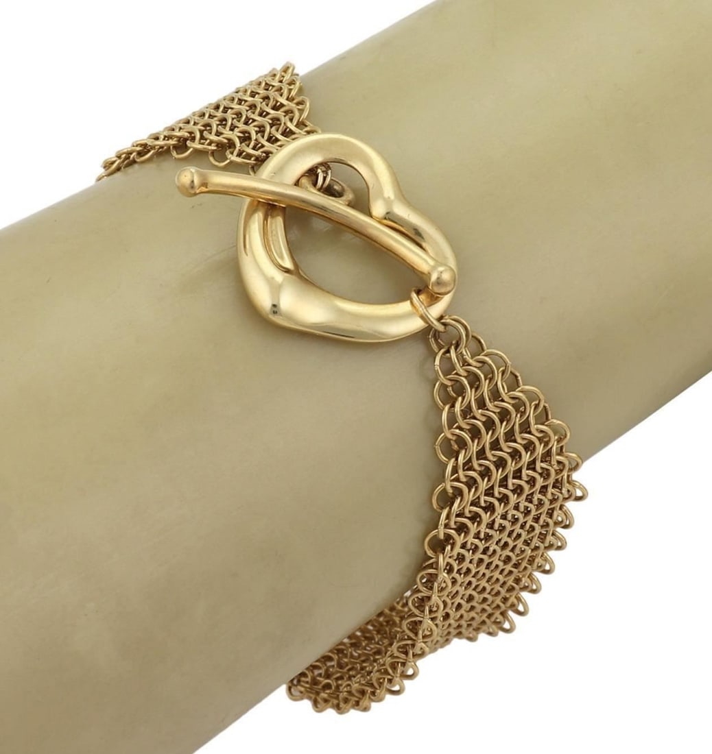 18k Yellow Gold Mesh Heart Toggle Bracelet Tiffany Co Elsa Peretti: 18k Yellow Gold Mesh Heart Toggle Bracelet Tiffany Co Elsa Peretti An Elsa Peretti Mesh Heart Toggle Bracelet in 18k yellow gold, featuring woven mesh links and a heart-shaped toggle clasp. The piece 