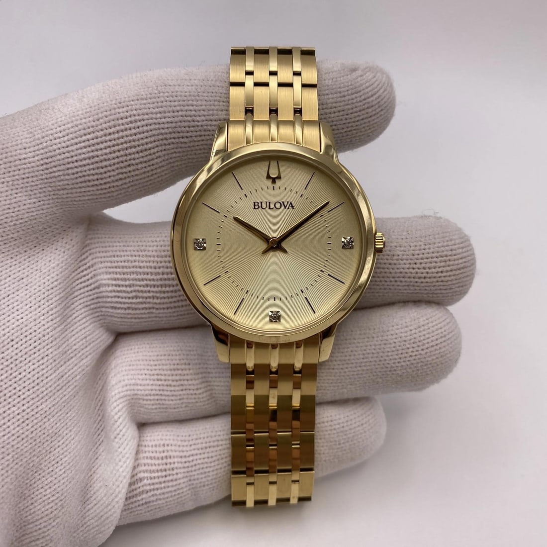 Bulova 97P123 Gold-Tone Ladies Watch with Champagne Dial: Bulova 97P123 Gold-Tone Ladies Watch with Champagne Dial This elegant Bulova Classic Diamond Accent Ladies Watch features a stunning champagne dial complemented by a fixed yellow gold-tone bezel. The 