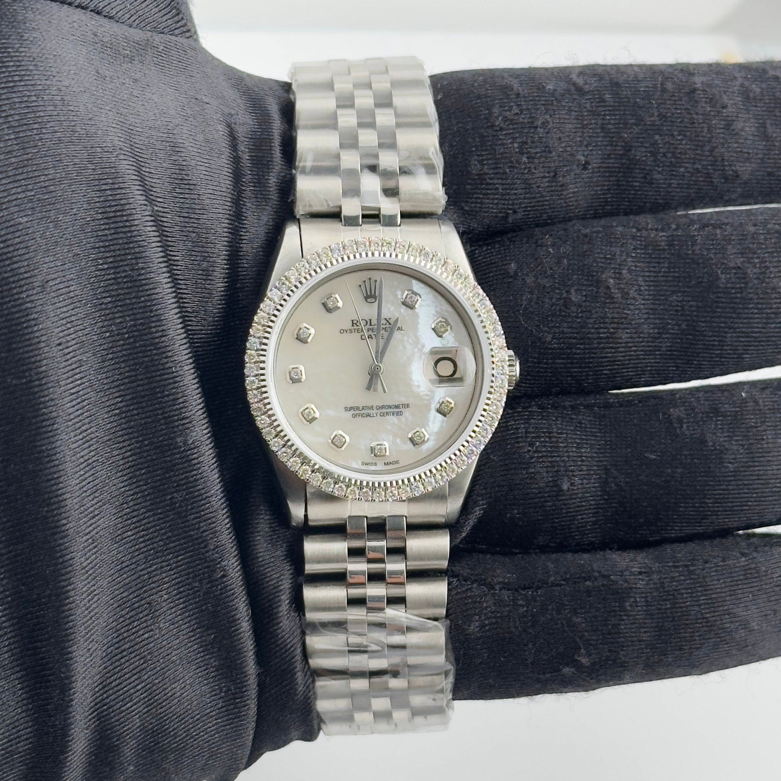 Rolex White Mother of Pearl Dial Aftermarket Jubilee Watch Ref 6694: Rolex White Mother of Pearl Dial Aftermarket Jubilee Watch Ref 6694 This Rolex Date watch features a white mother-of-pearl dial and a prong diamond bezel, complemented by an aftermarket Jubilee bracel
