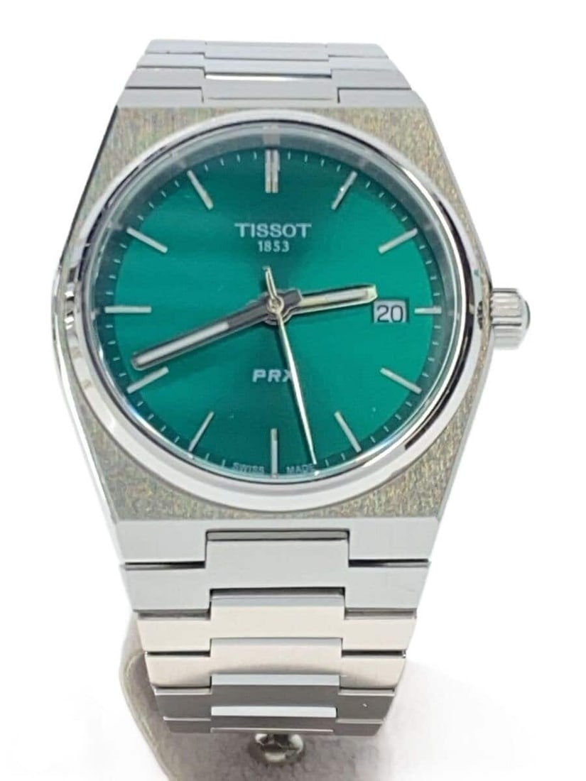 Tissot PRX Quartz Green Dial Stainless Steel Wristwatch 35mm: Tissot PRX Quartz Green Dial Stainless Steel Wristwatch 35mm This TISSOT PRX 35mm Quartz T137210A men's wristwatch features a green dial and a stainless steel case and band. Designed in Switzerland, i