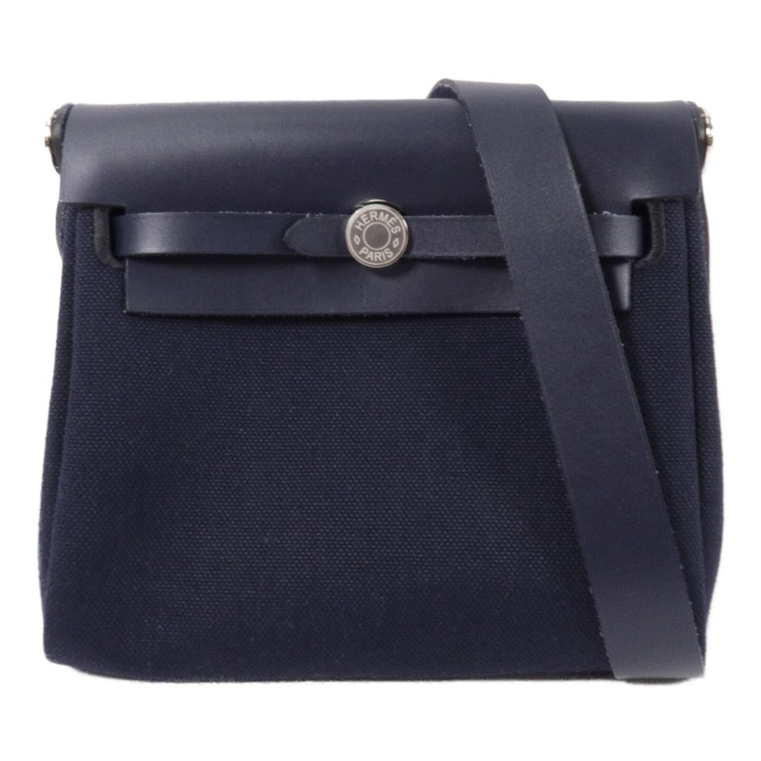 Hermes Mini Herbag Canvas Shoulder Bag Bleu Indigo PHW: Hermes Mini Herbag Canvas Shoulder Bag Bleu Indigo PHW Hermes PHW Mini Herbag Shoulder Bag in canvas with a Bleu Indigo colorway. The bag features a G stamp, indicating manufacture in 2026, and is pre