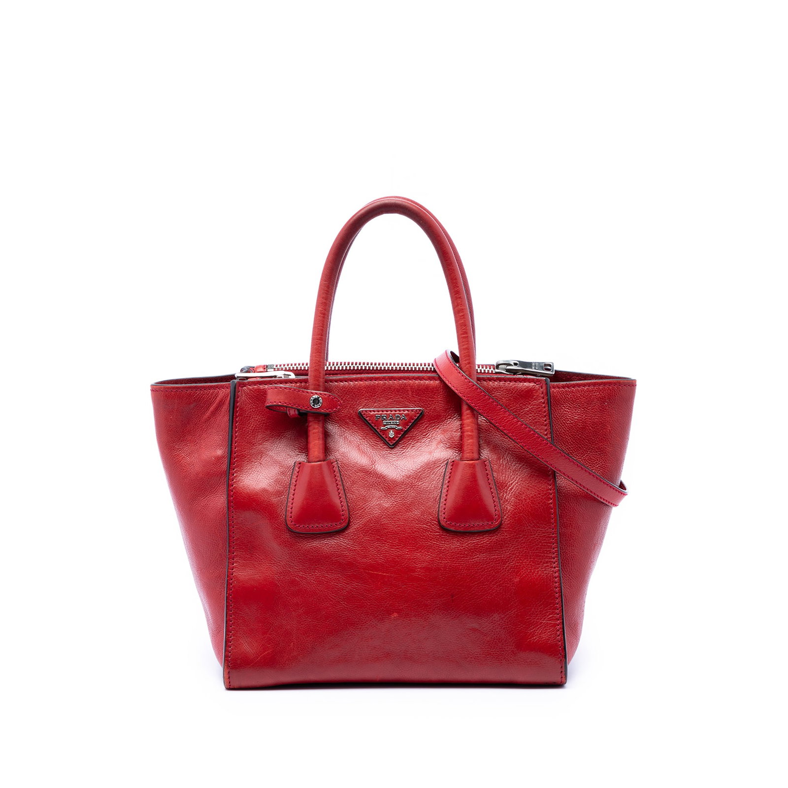 Prada Glace Calf Leather Satchel with Twin Zip Pockets: Prada Glace Calf Leather Satchel with Twin Zip Pockets Prada Glace Calf Twin Pocket Satchel in red leather with rolled handles and a detachable flat shoulder strap. The design features an open top wit