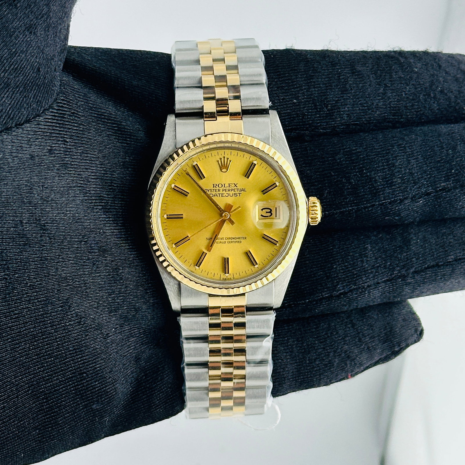 Rolex Datejust 16013 Champagne Stick Dial Aftermarket Jubilee Bracelet: Rolex Datejust 16013 Champagne Stick Dial Aftermarket Jubilee Bracelet This is a men's Rolex Datejust wristwatch featuring a champagne stick dial and a fluted bezel. The watch is equipped with an afte