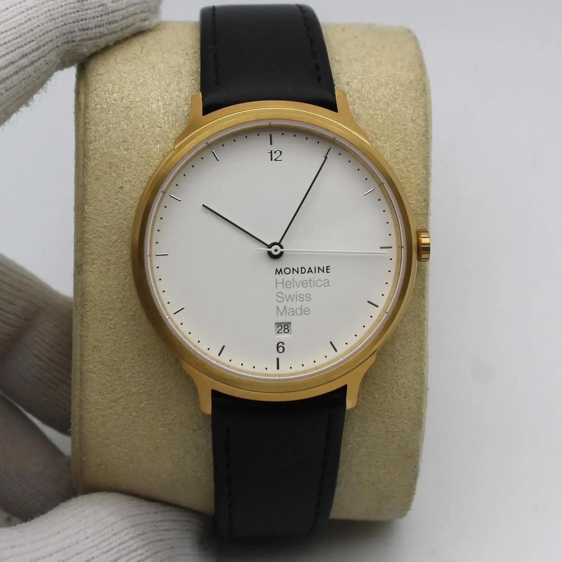 Unisex Helvetica No1 Light Gold Stainless Steel Quartz Watch White Dial Black Strap: Unisex Helvetica No1 Light Gold Stainless Steel Quartz Watch White Dial Black Strap This Mondaine Helvetica No1 Light wristwatch features a gold-tone stainless steel case with a white analog dial and 
