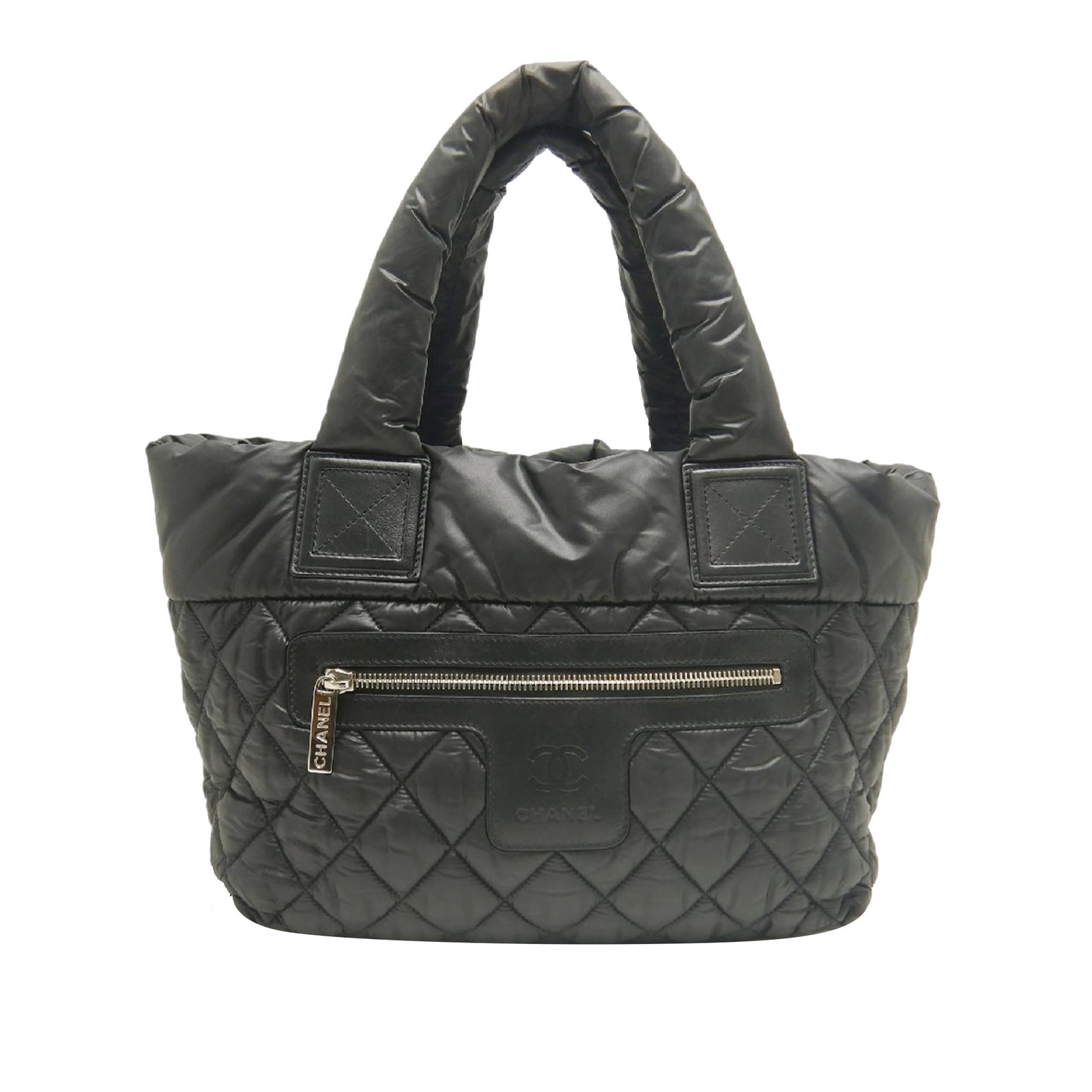 Chanel Coco Cocoon Small Quilted Nylon Tote Bag Black: Chanel Coco Cocoon Small Quilted Nylon Tote Bag Black Small quilted nylon Coco Cocoon tote bag by Chanel, made in Italy. It features a quilted nylon body with leather trim, an exterior front zip pocke