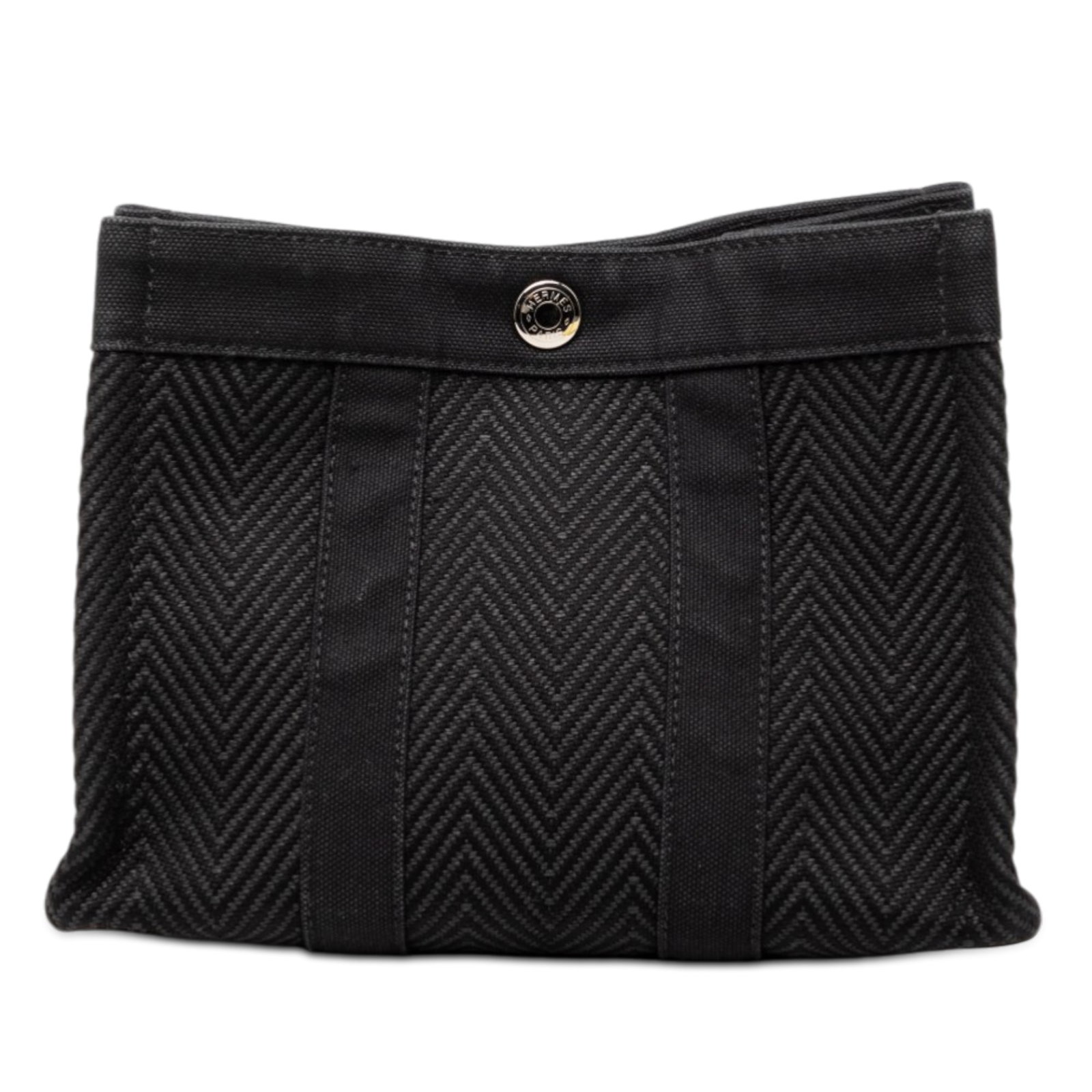 Chevron Canvas Fourre Tout Pouch by Hermes in Black Fabric: Chevron Canvas Fourre Tout Pouch by Hermes in Black Fabric This Hermes Fourre Tout pouch features a chevron-pattern canvas body in black and an open top with a snap button closure. The pouch is catego