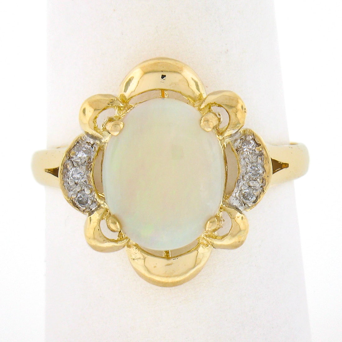 14k Yellow Gold Australian Opal Ring with Diamond Accents and Scalloped Frame: 14k Yellow Gold Australian Opal Ring with Diamond Accents and Scalloped Frame This exquisite ring features a stunning natural Australian opal set in solid 14k yellow gold. The oval cabochon cut opal, 