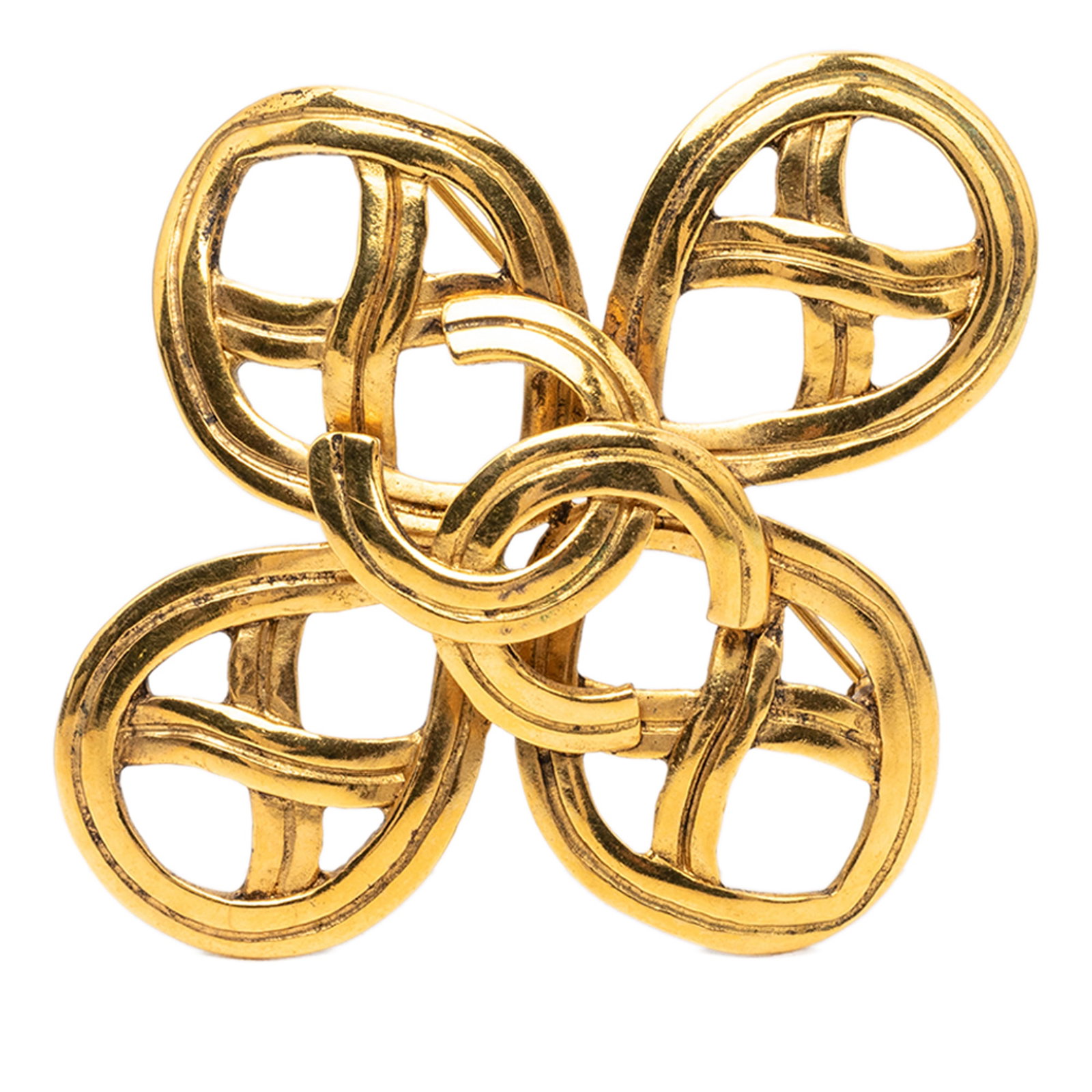 Chanel Infinity CC Gold Plated Brooch: Chanel Infinity CC Gold Plated Brooch Gold plated metal brooch with a CC infinity design and back pin closure. Made in France and classified as costume jewelry. The piece is gold in color and measures