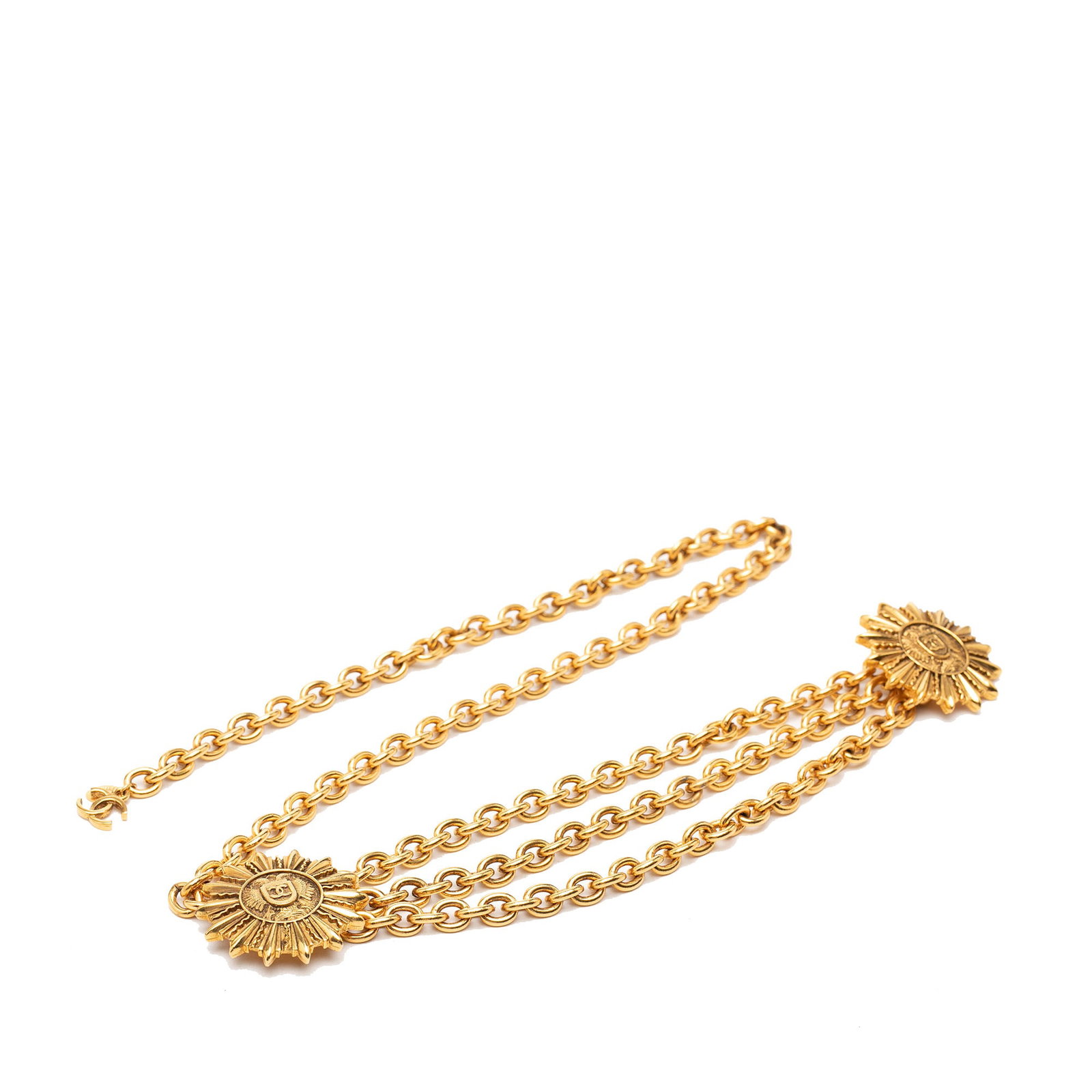 Chanel CC Triple Chain Belt with Gold Tone Sun Medallions: Chanel CC Triple Chain Belt with Gold Tone Sun Medallions Chanel triple chain belt featuring a CC sun medallion design and hook closure. The gold-tone metal construction gives it a bold statement look