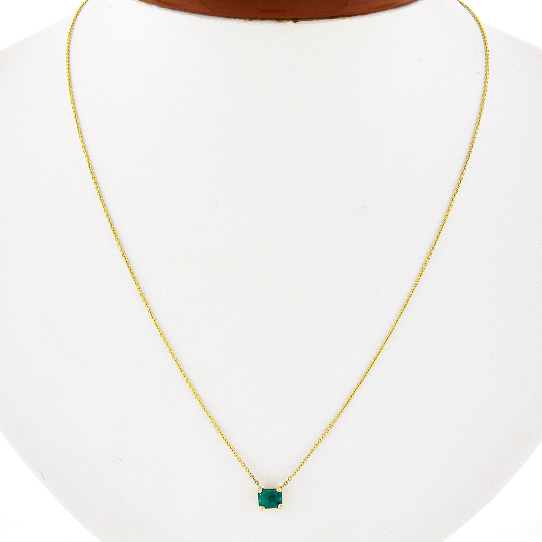 14K Yellow Gold Emerald Solitaire Pendant Necklace 0.37ct Cable Chain: 14K Yellow Gold Emerald Solitaire Pendant Necklace 0.37ct Cable Chain This un-used necklace features a natural emerald-cut emerald solitaire, prong set in solid 14k yellow gold. The vivid green emeral