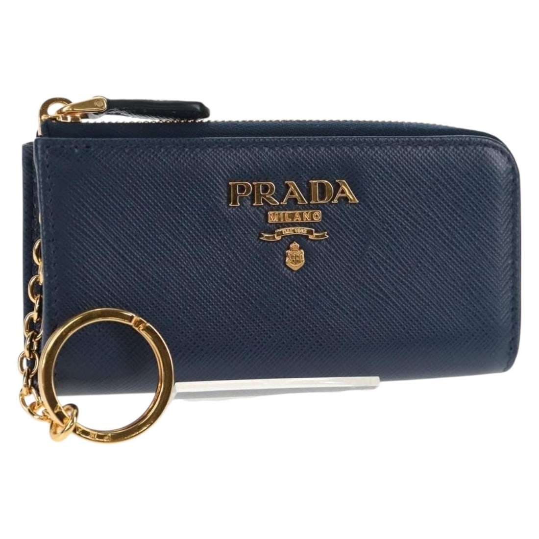 PRADA Navy Saffiano Leather Key Case Authentic AM9283V: PRADA Navy Saffiano Leather Key Case Authentic AM9283V This authentic PRADA key case is crafted from premium Saffiano leather in a sophisticated navy color. Designed for functionality, it features a c