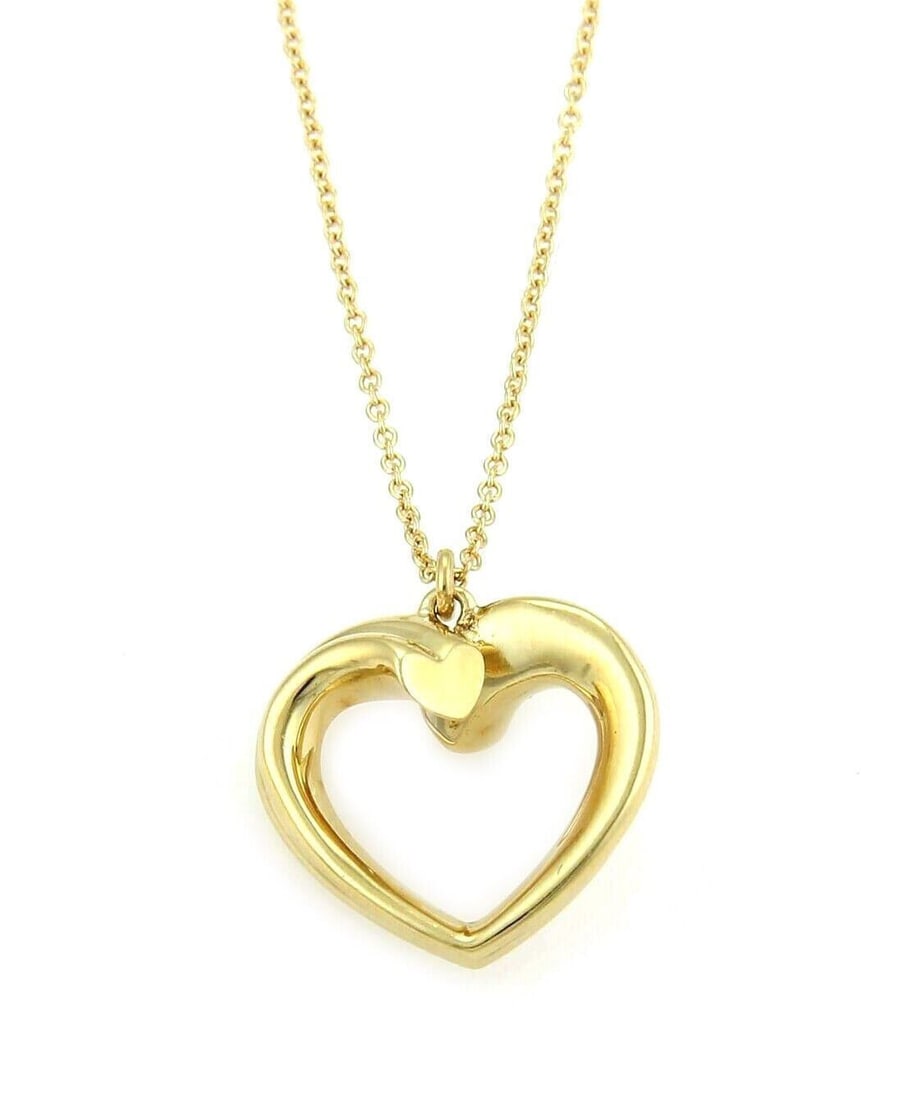 Tiffany & Co. Paloma Picasso Tenderness Heart Necklace in 18k Yellow Gold: Tiffany & Co. Paloma Picasso Tenderness Heart Necklace in 18k Yellow Gold A pre-owned Tiffany & Co. Paloma Picasso Tenderness Heart Pendant Necklace crafted in 18k yellow gold. The design features a s
