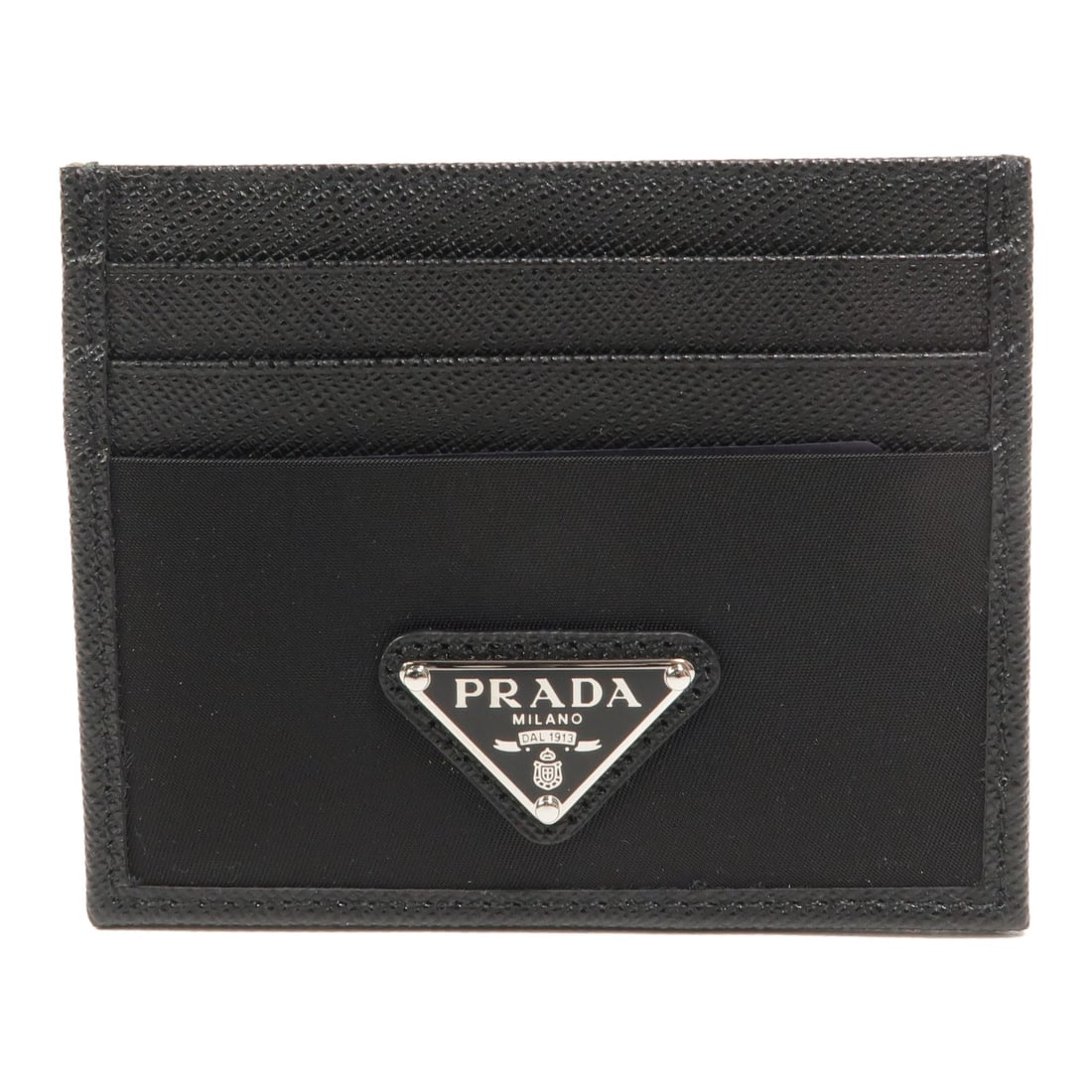 PRADA 2MC025 card holder in black Re-Nylon and Saffiano leather: PRADA 2MC025 card holder in black Re-Nylon and Saffiano leather This PRADA card holder is made from Saffiano leather and nylon in black. It features seven card slots and comes with a storage box. The 