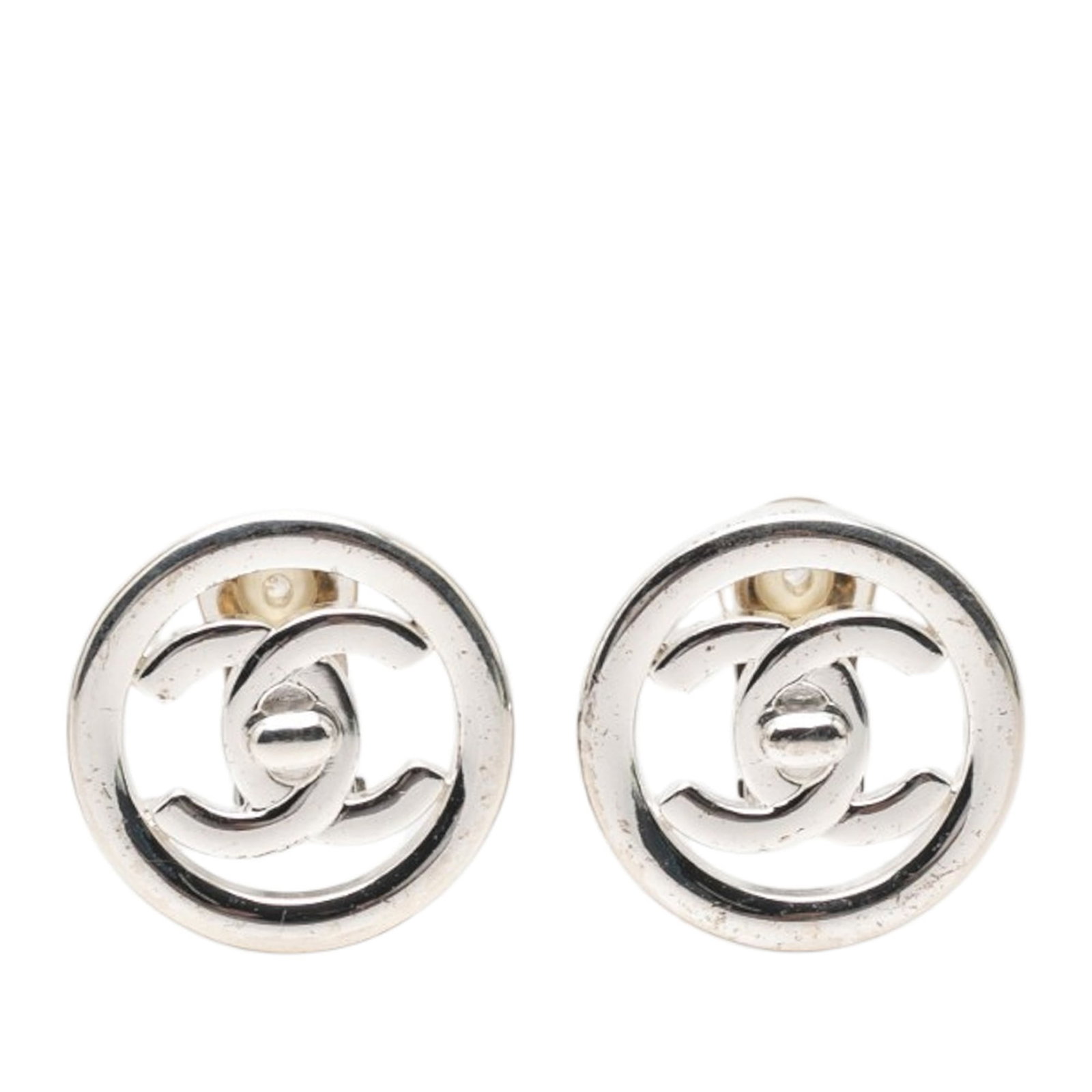 Chanel CC Brass Turnlock Clip On Earrings: Chanel CC Brass Turnlock Clip On Earrings These Chanel CC Brass Turnlock Round Clip On Earrings feature a silver tone metal construction and secure clip-on closures. Made in France, these costume earr
