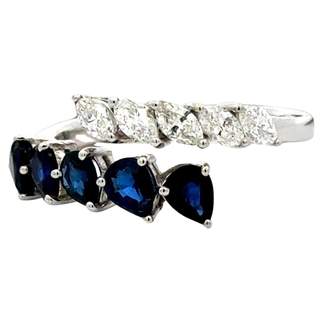 Bypass Ring in 18K White Gold with Marquise Diamonds and Pear Sapphires 1.95cttw: Bypass Ring in 18K White Gold with Marquise Diamonds and Pear Sapphires 1.95cttw This contemporary bypass ring features an elegant design crafted in 18K white gold. The open bypass style showcases mir
