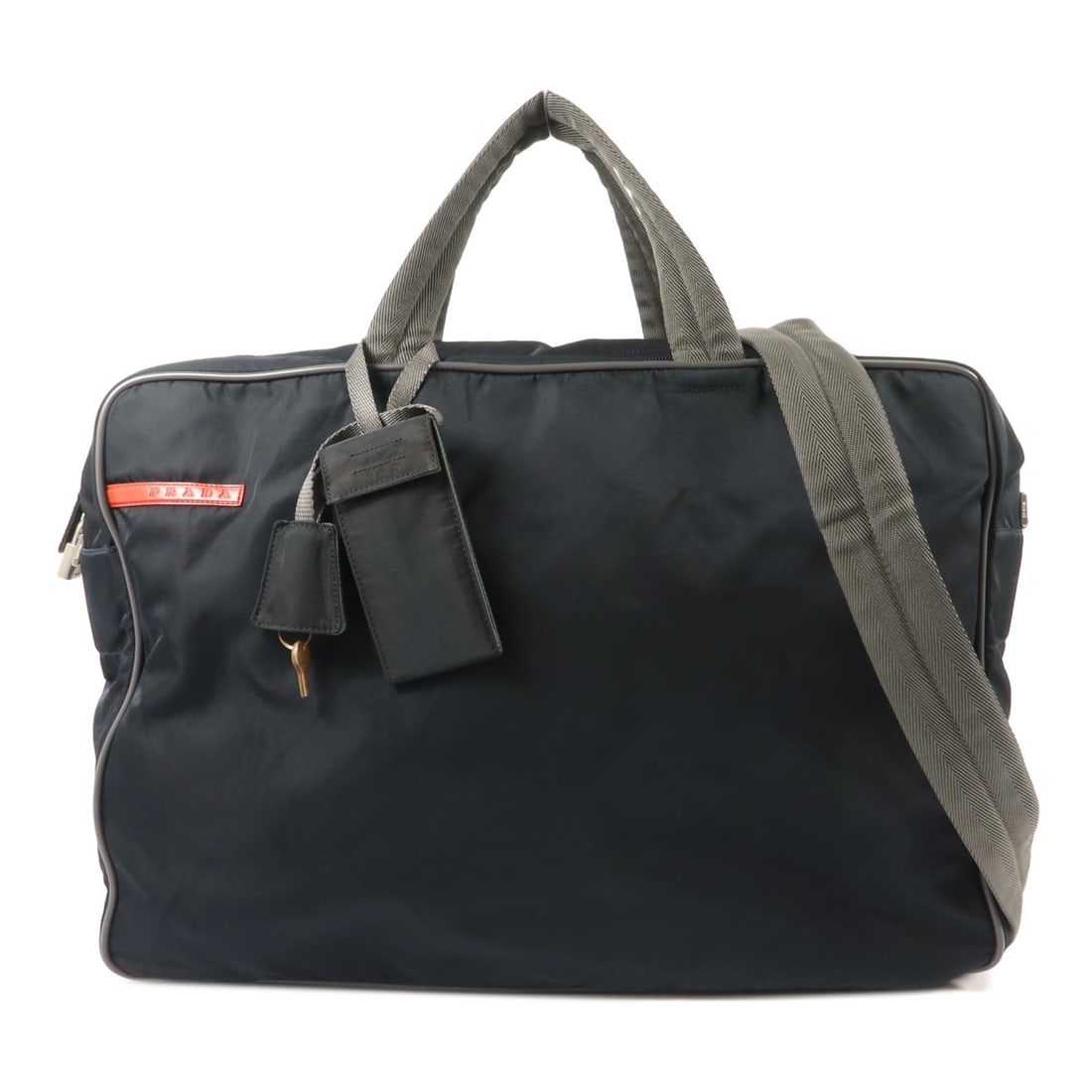 PRADA nylon 2 way shoulder bag in navy with strap: PRADA nylon 2 way shoulder bag in navy with strap Prada 2-way shoulder bag in navy nylon with silver-tone hardware. It features a fastener closure, one inside zip pocket, one other pocket, and comes w
