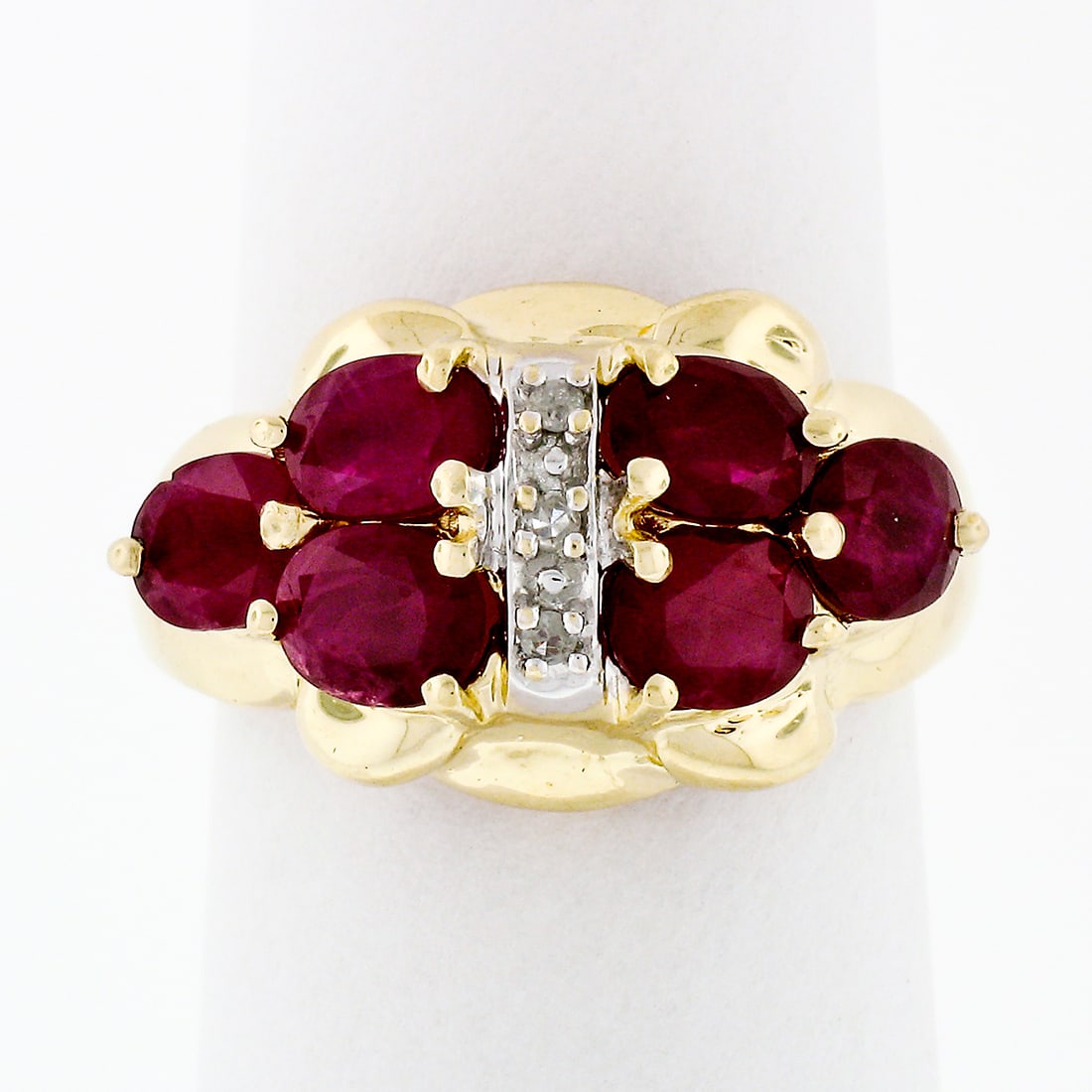 14k Gold 3.65ctw Deep Red Ruby Band Ring with Diamond Accents: 14k Gold 3.65ctw Deep Red Ruby Band Ring with Diamond Accents This stunning ring showcases a captivating design crafted from solid 14k yellow and white gold. It features an exquisite arrangement of ov