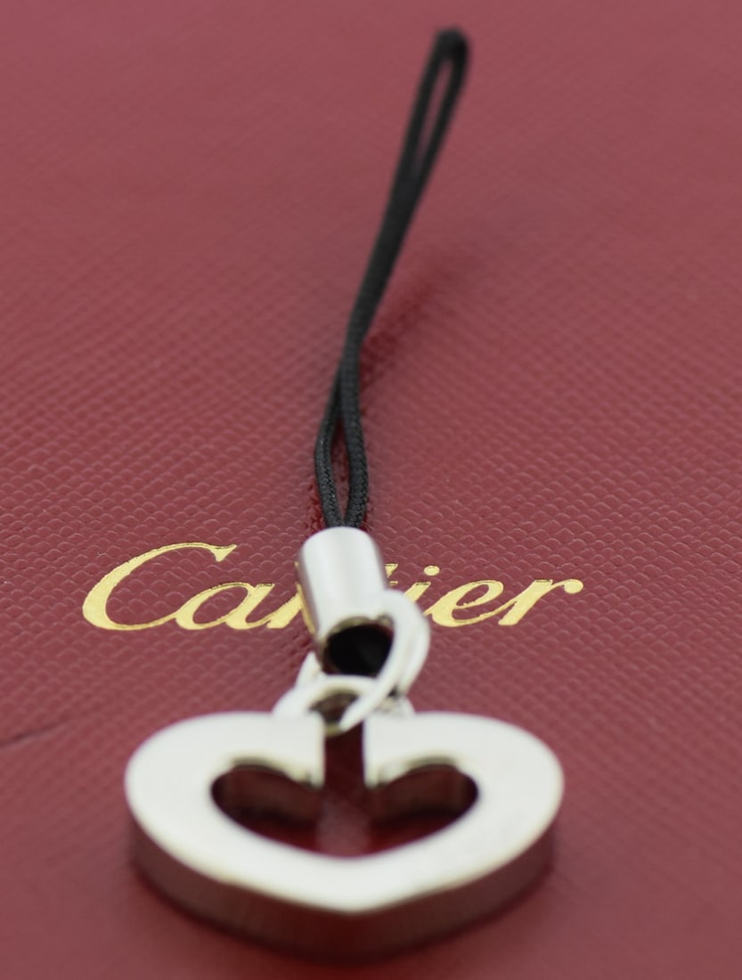 Stainless Steel Heart Shape Key Ring by Cartier with Original Box: Stainless Steel Heart Shape Key Ring by Cartier with Original Box This Cartier key ring features a heart design crafted from stainless steel in a silver tone. Designed for unisex use, it offers both d
