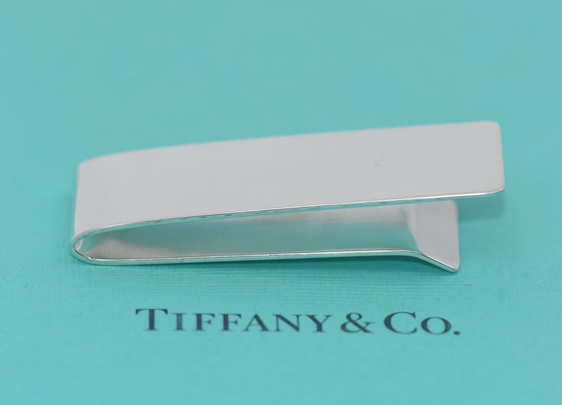 Sterling Silver Men's Money Clip by Tiffany & Co with Pouch: Sterling Silver Men's Money Clip by Tiffany & Co with Pouch This Tiffany & Co. money clip is crafted from sterling silver and features a sleek, classic design. Made in Italy, it is designed for men an