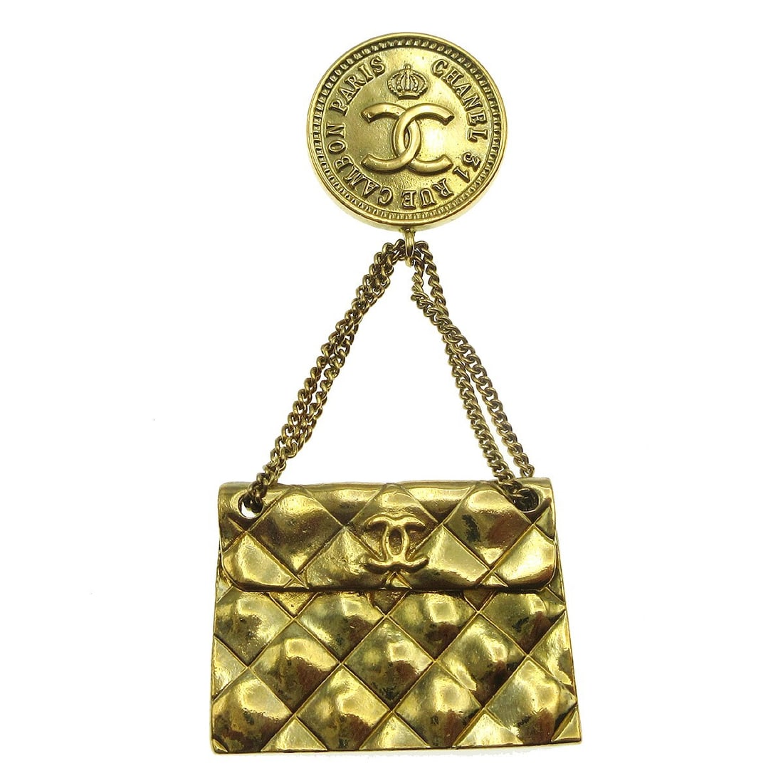 Chanel CC quilted bag motif gold plated brooch pin: Chanel CC quilted bag motif gold plated brooch pin Gold-plated Chanel brooch in a quilted bag motif design. Made in France, this gold-tone pin shows reasonable wear with scratches and discoloration co