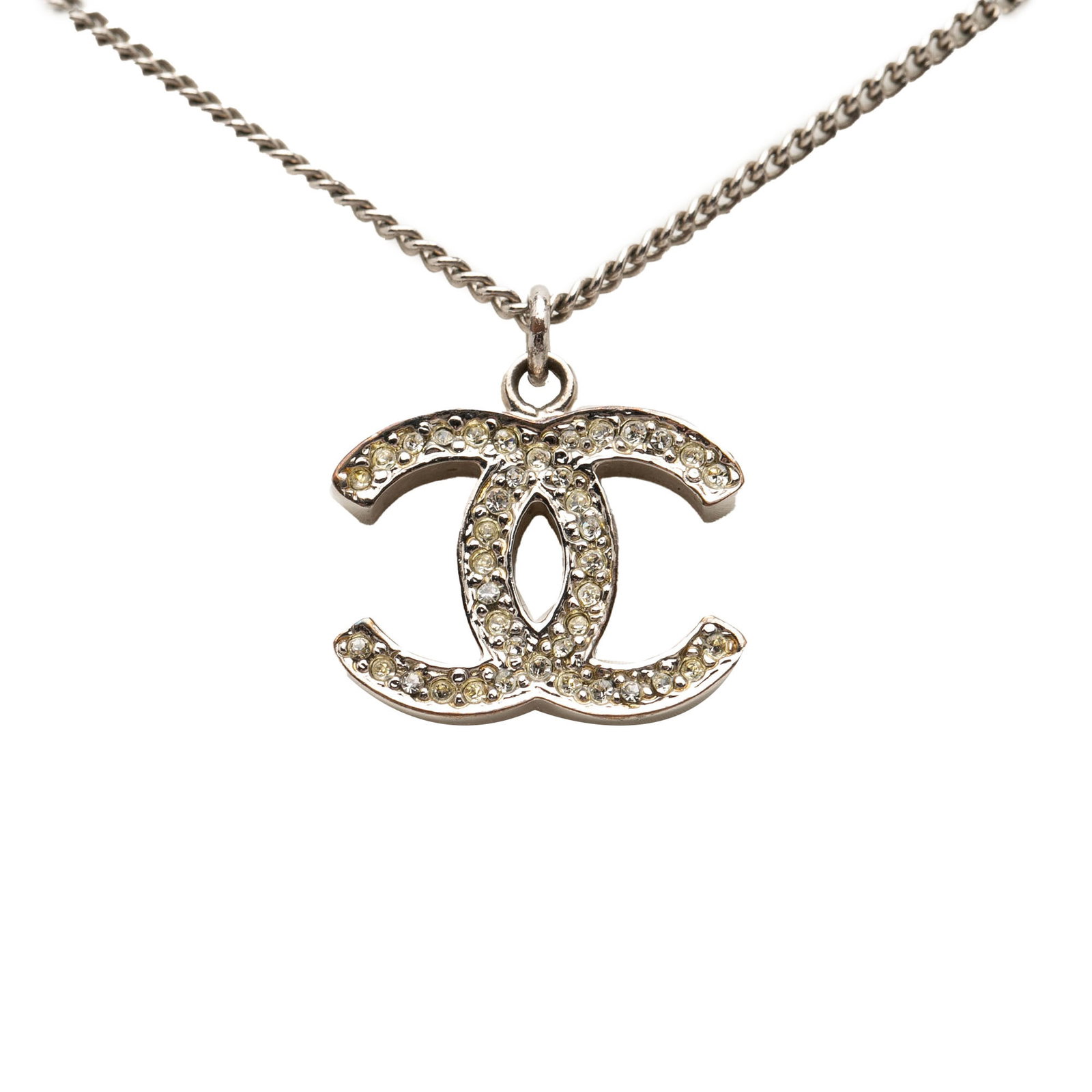 Chanel CC pendant necklace silver tone rhinestones: Chanel CC pendant necklace silver tone rhinestones This Chanel necklace showcases a silver tone metal construction adorned with rhinestone embellishments and is secured with a lobster clasp closure. T