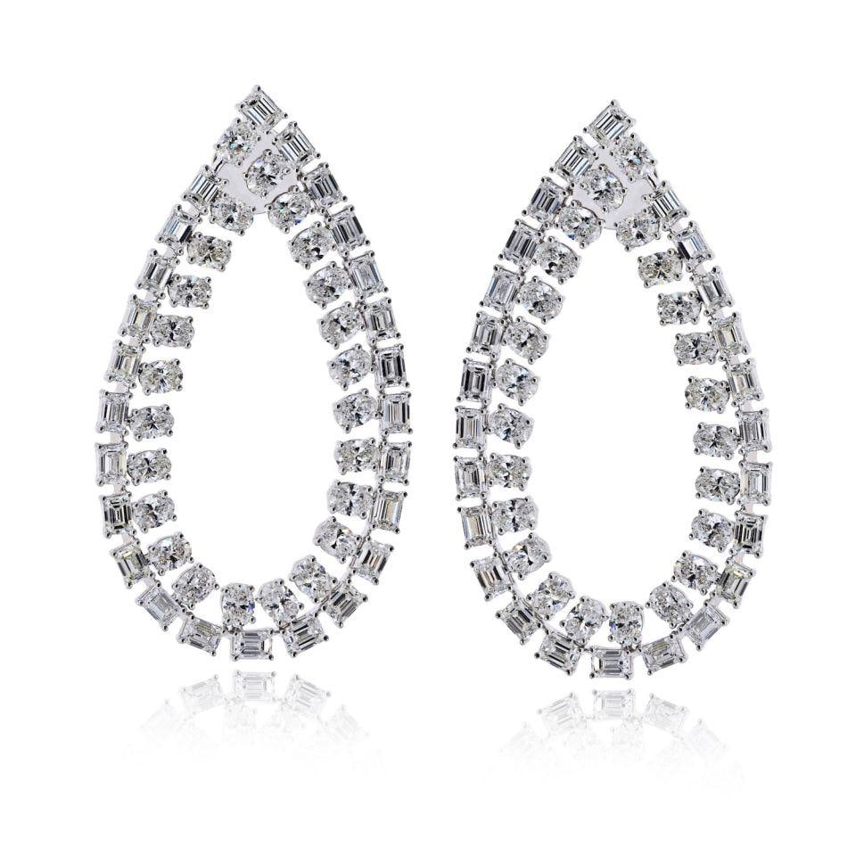 18K White Gold Pear Drop Diamond Earrings 19.60cttw: 18K White Gold Pear Drop Diamond Earrings 19.60cttw These 18K white gold earrings showcase an elongated open pear silhouette adorned with alternating emerald-cut and oval-cut diamonds, totaling approx