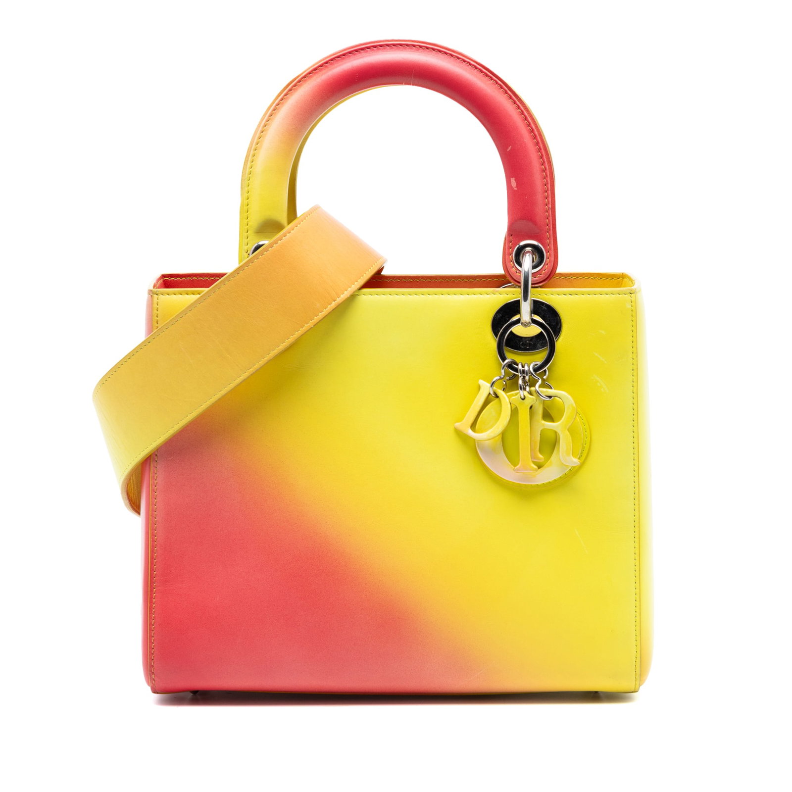 Dior Medium Lady handbag ombre calfskin yellow leather: Dior Medium Lady handbag ombre calfskin yellow leather This Medium Ombre Calfskin Lady Dior handbag features a gradient leather body with flat top handles and a detachable flat leather strap. It is de
