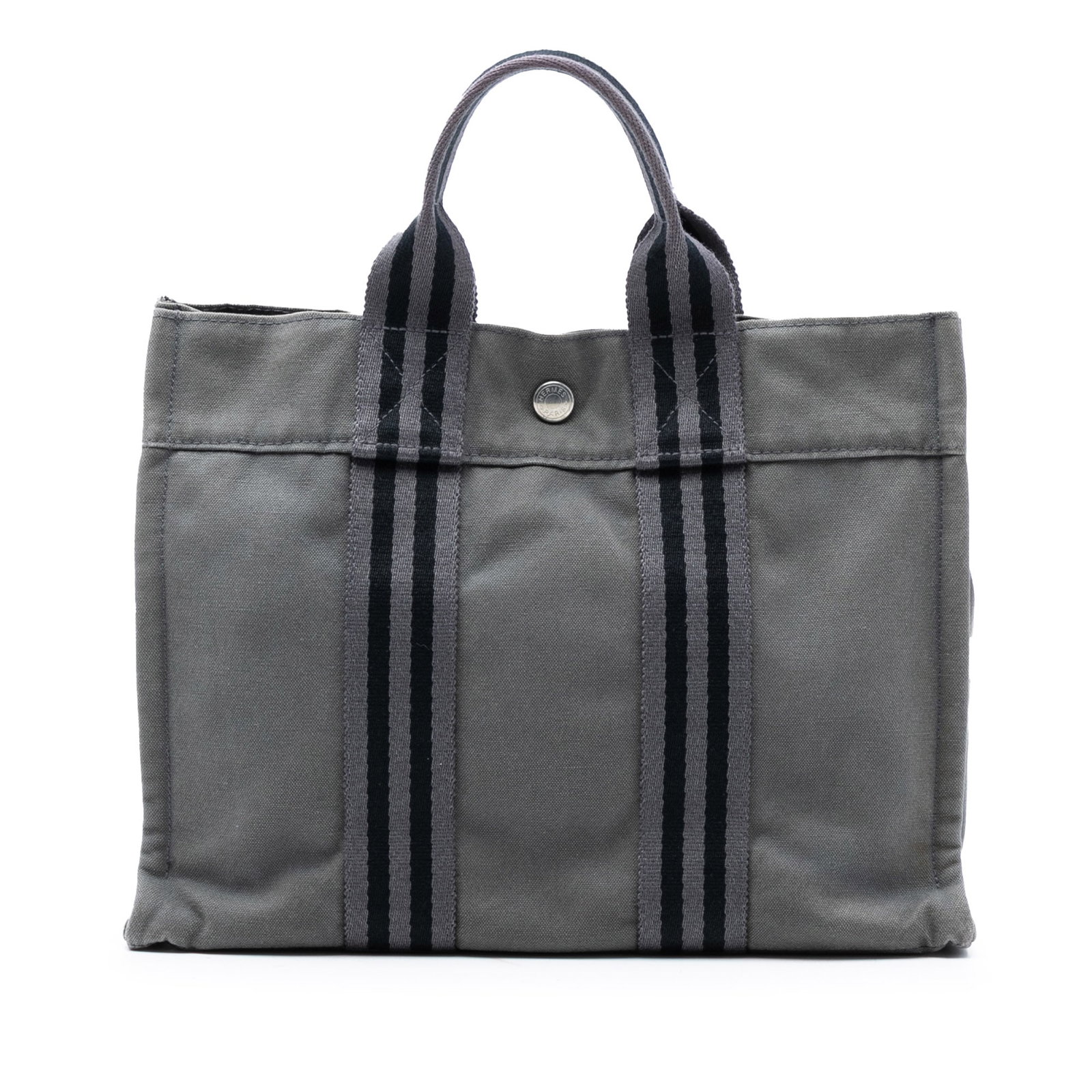Hermes Fourre Tout PM Gray Canvas Tote Bag with Snap Closure: Hermes Fourre Tout PM Gray Canvas Tote Bag with Snap Closure The Hermes Fourre Tout PM is crafted with a durable canvas body and features flat straps, an open top with a snap closure, and an interior 