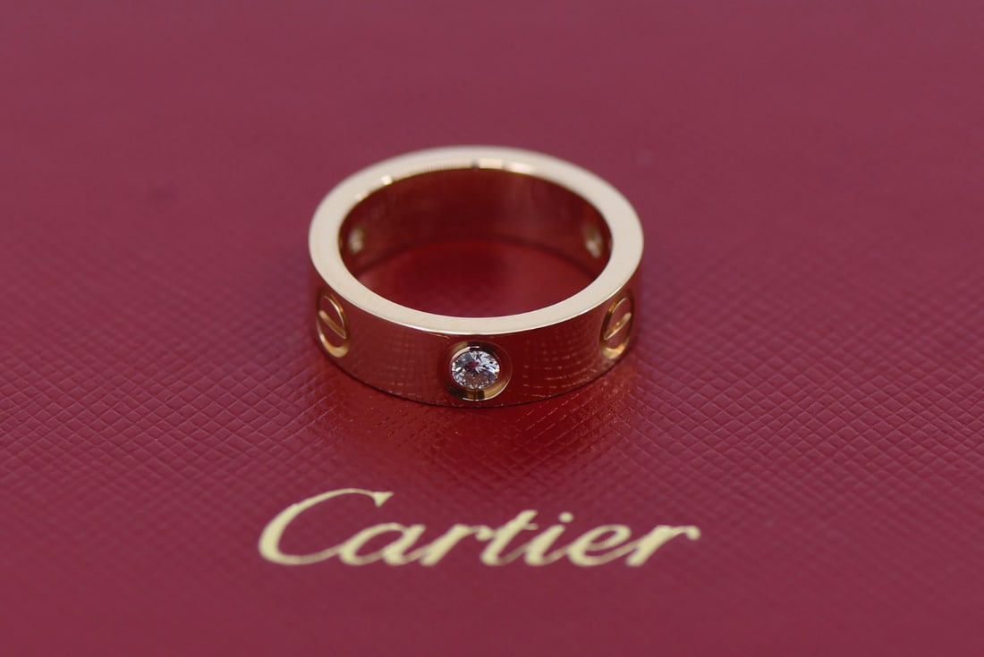 Love Ring by Cartier in 18K Rose Gold with Three Diamonds Size 50: Love Ring by Cartier in 18K Rose Gold with Three Diamonds Size 50 This Cartier Love ring features three diamonds set in 18K rose gold. Designed with a pink hue and the iconic Love theme, the ring is c