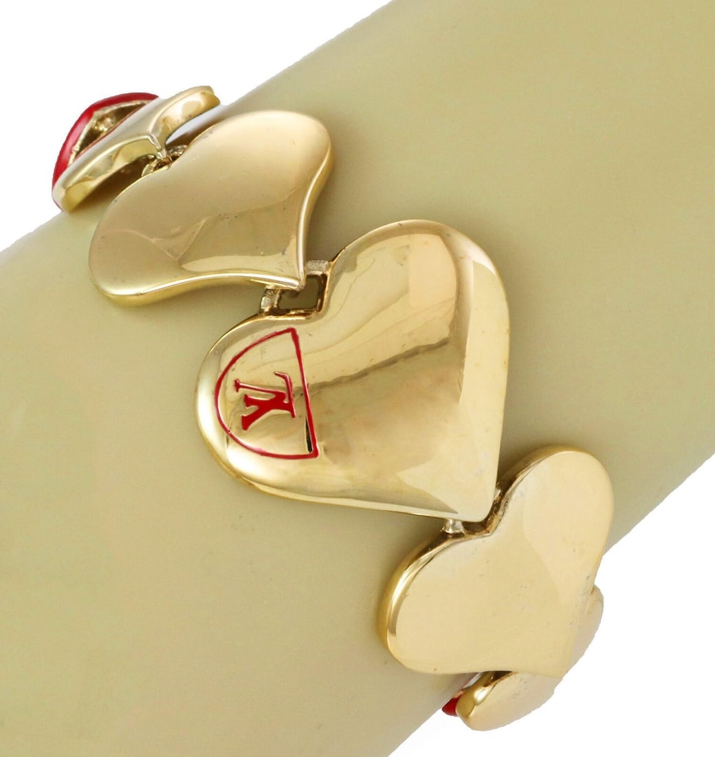 Louis Vuitton Heart Link Bracelet Gold Plated Red Enamel: Louis Vuitton Heart Link Bracelet Gold Plated Red Enamel Vintage Louis Vuitton bracelet with bold oversized heart links and the iconic LV motif, accented by vibrant red enamel detailing. It has a rich