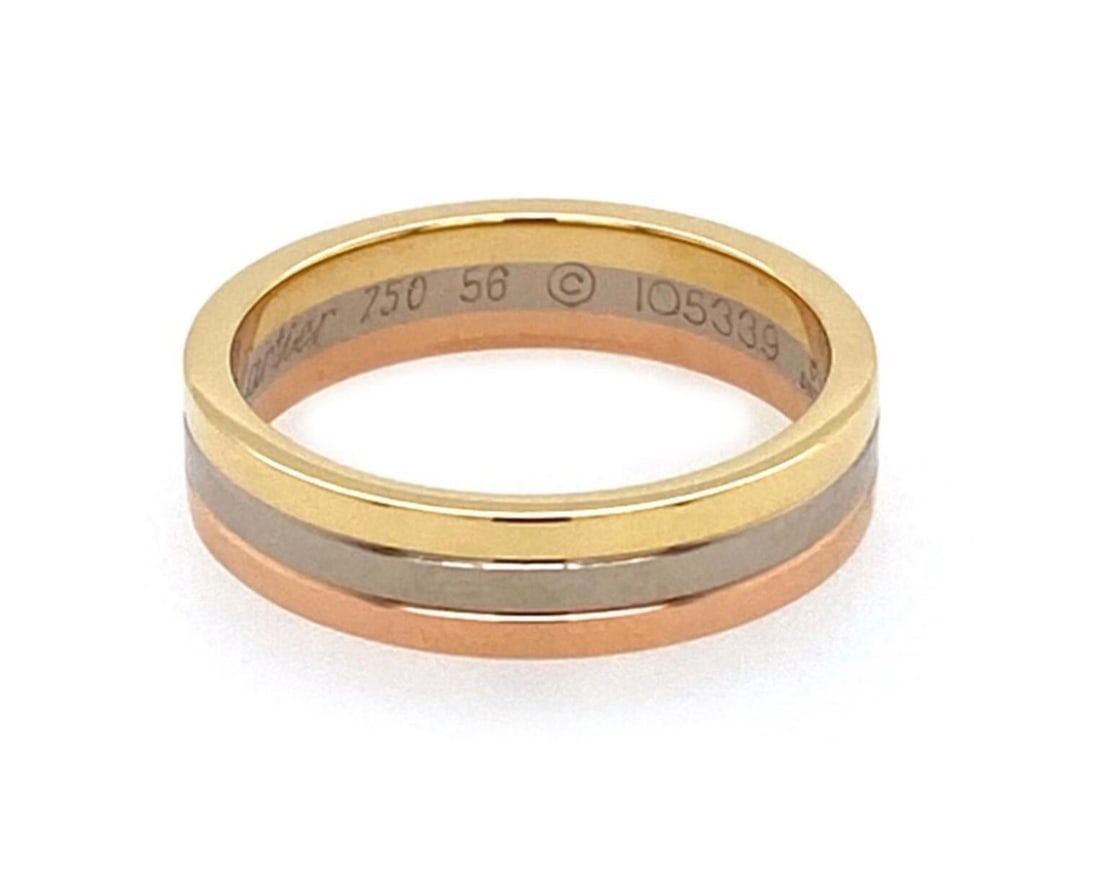 Cartier Vendome Louis tri color 18k gold band ring size 56 with paper: Cartier Vendome Louis tri color 18k gold band ring size 56 with paper A pre-owned Cartier Vendome Louis band ring crafted in 18k yellow, white, and rose gold. The ring features an iconic polished tri-