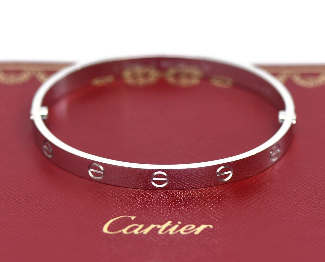 Cartier Love Bangle Bracelet 18K White Gold Size 18: Cartier Love Bangle Bracelet 18K White Gold Size 18 A Cartier Love bracelet in 18K white gold, presented in size 18. The bracelet is pre-owned and comes with a box and certificate. It is a bangle styl